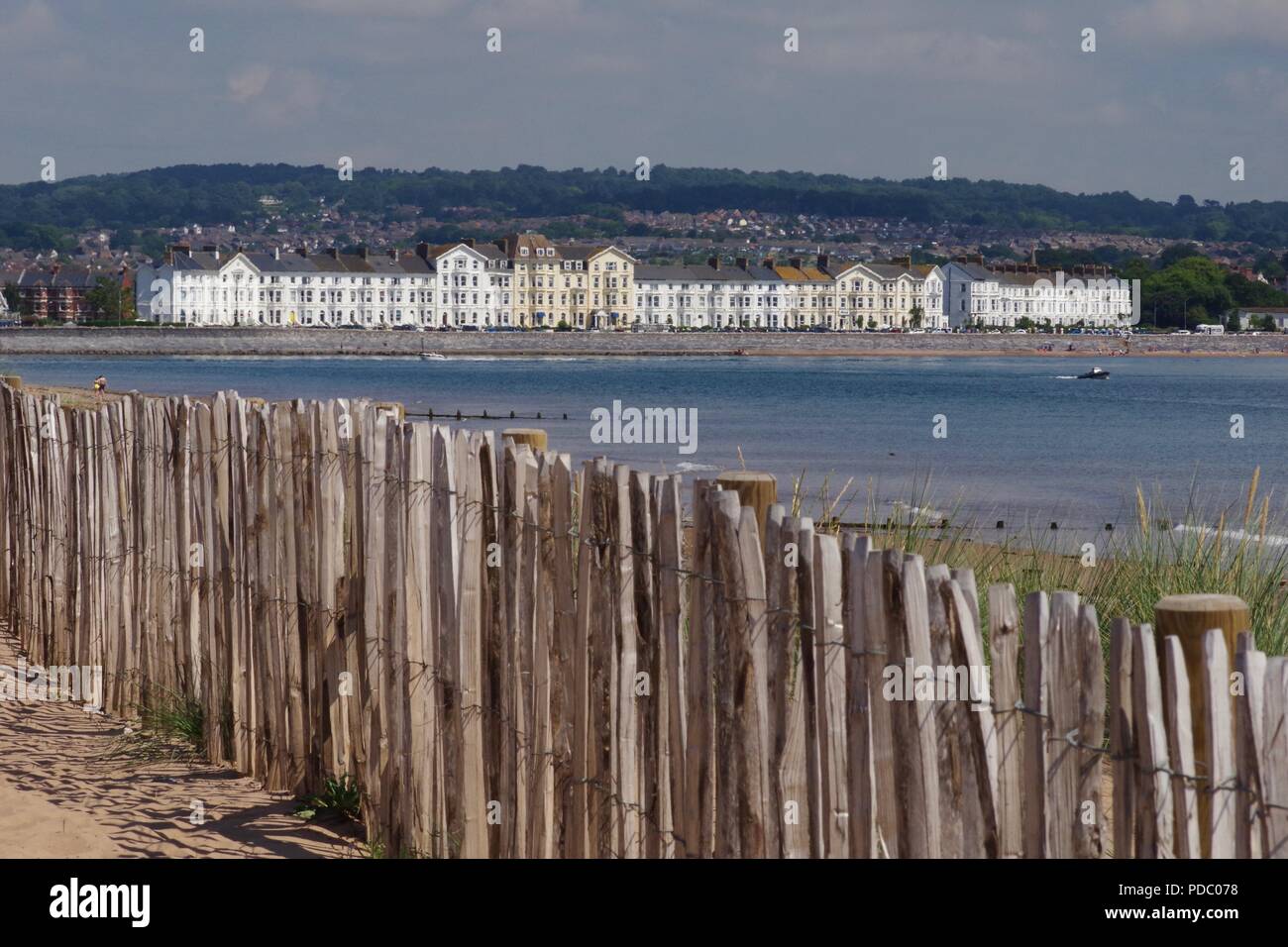 Period Property along Exmouth Seafront Strand, Seen from Dawlish Warren on a Summers Day. Sand Dune Stabilisation Fence in Foreground. Devon, UK. Stock Photo