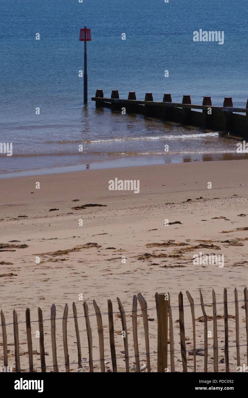 Wooden Groynes along Dawlish Warren Beach on a Calm, Sunny Summers Day. Devon, UK. Stock Photo