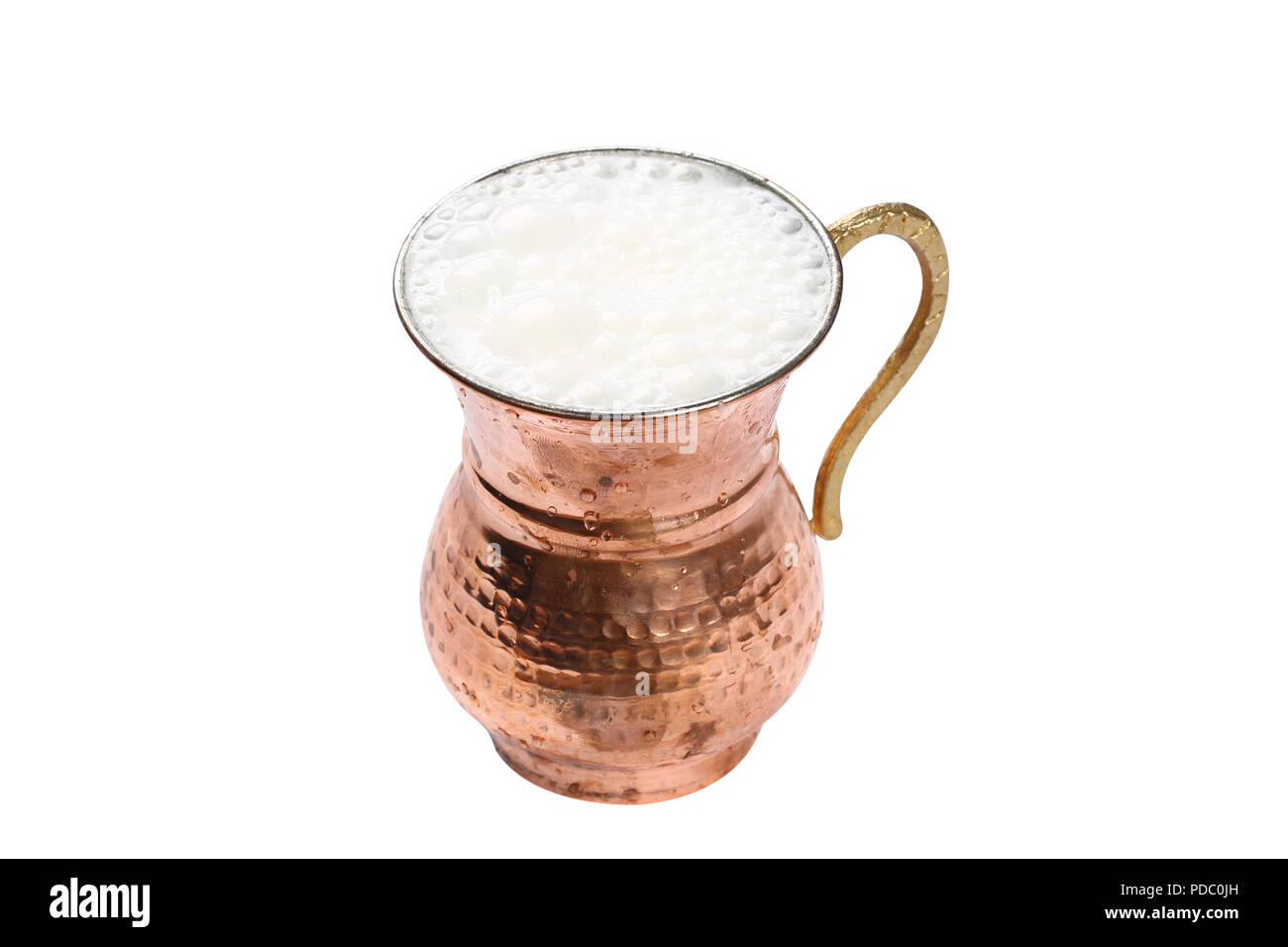 Turkish Drink Ayran or Buttermilk with foam in copper cup Stock Photo