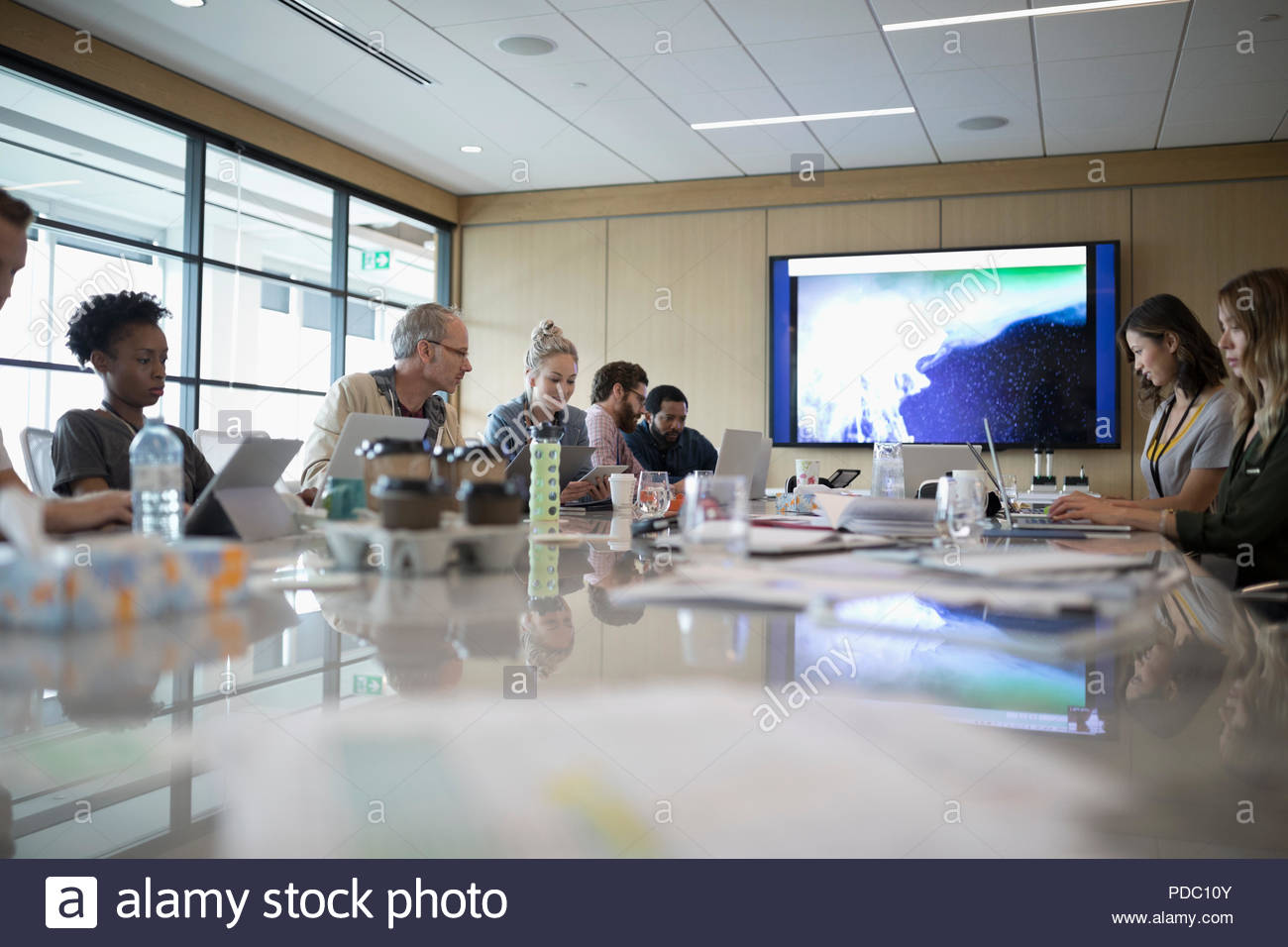 Creative business people using laptops and digital tablets in