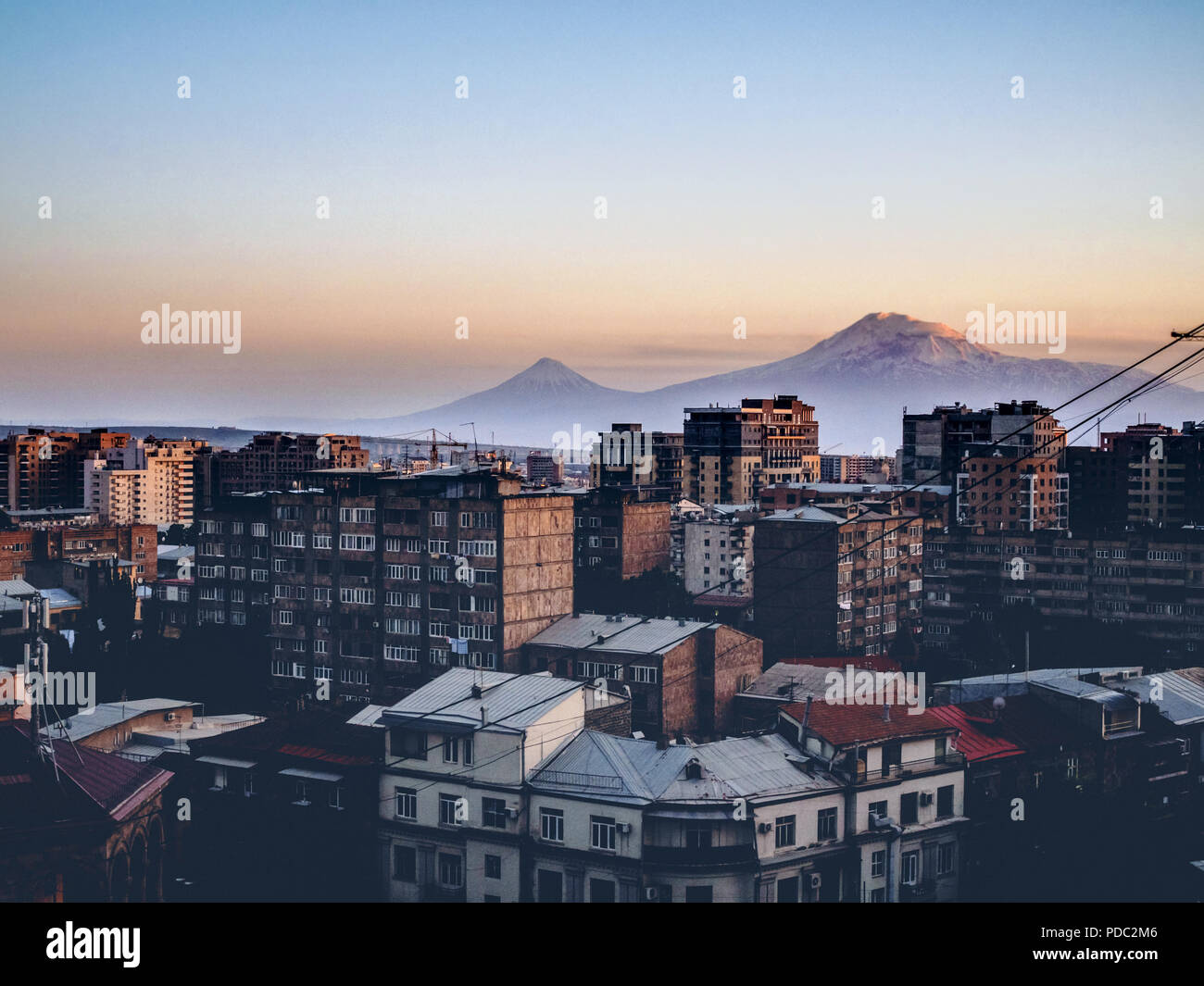 aerial view of Yerevan city on twilight with mountains on background