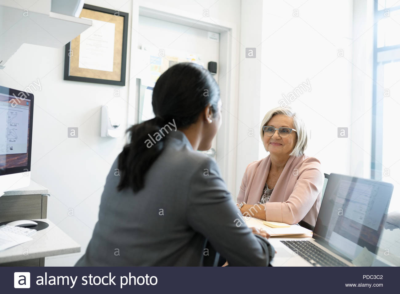 Woman and doctor office talking hi-res stock photography and images - Alamy