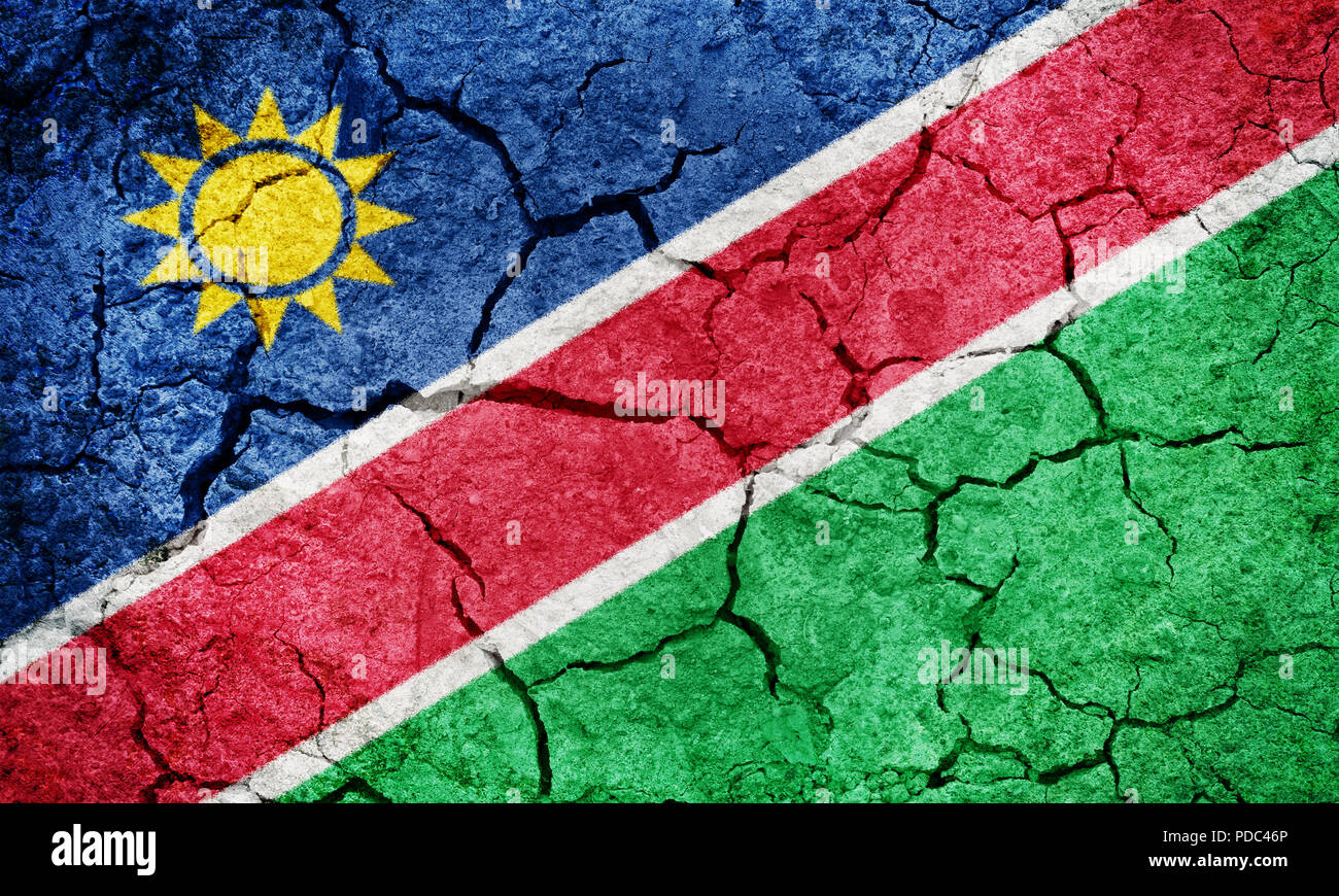 Republic of Namibia flag on dry earth ground texture background Stock Photo