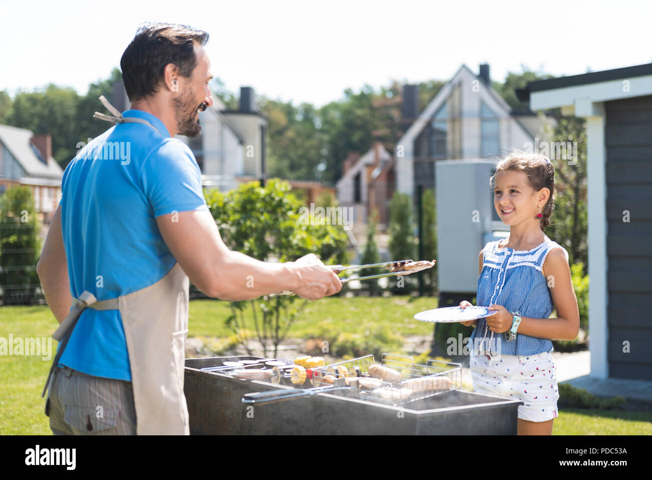 Positive nice man looking at his daughter Stock Photo