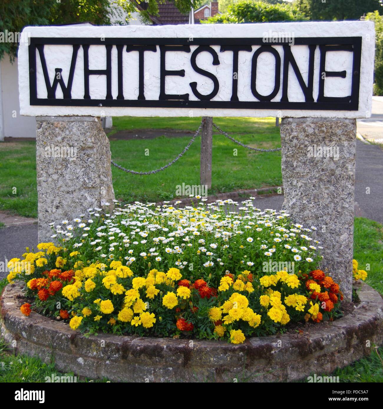 Whitestone Village Sign and Flower Bed at the Entrance to a Quaint