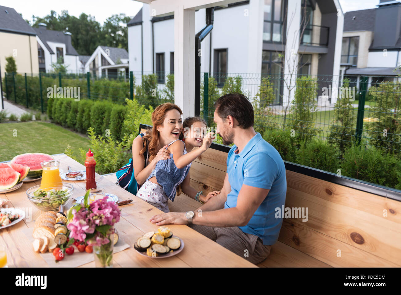 Nice joyful family eating outside Stock Photo