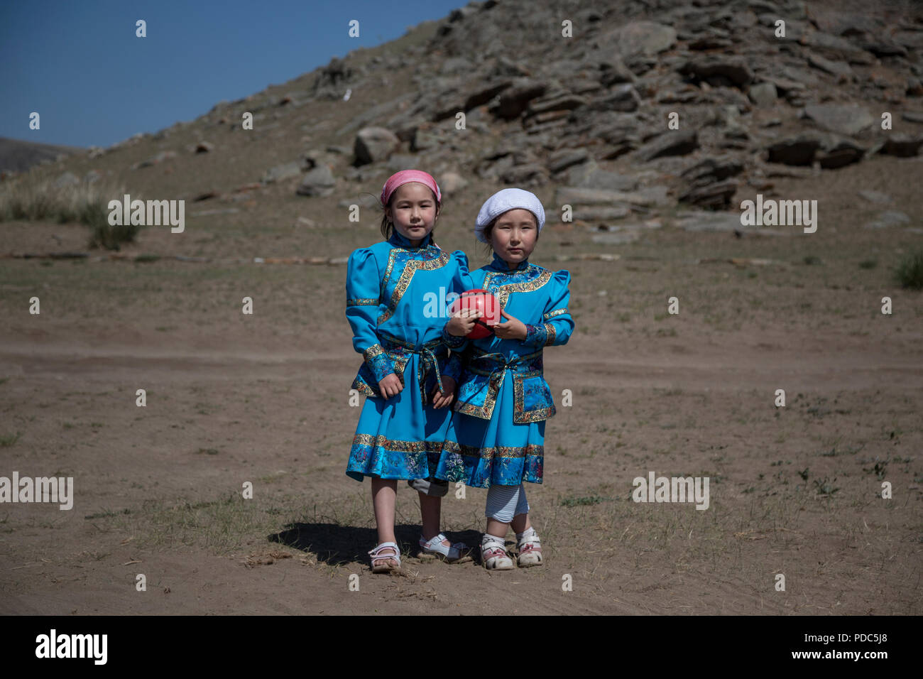 Buryat sister girls in national costume near sacred mountain Erd located 2 km from Baikal lake, Irkutsk oblast, Russia Stock Photo