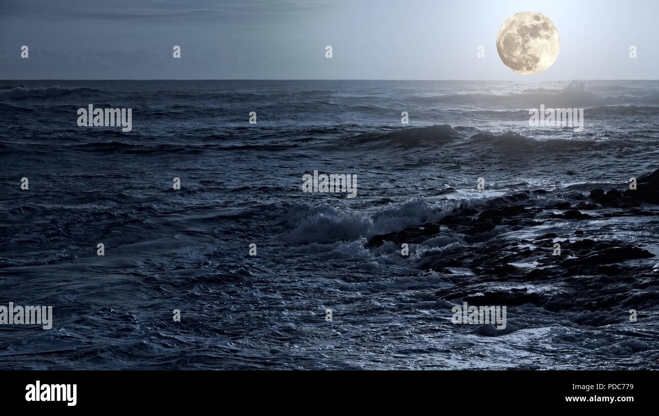 Arising full moon over east sea coast Stock Photo Alamy