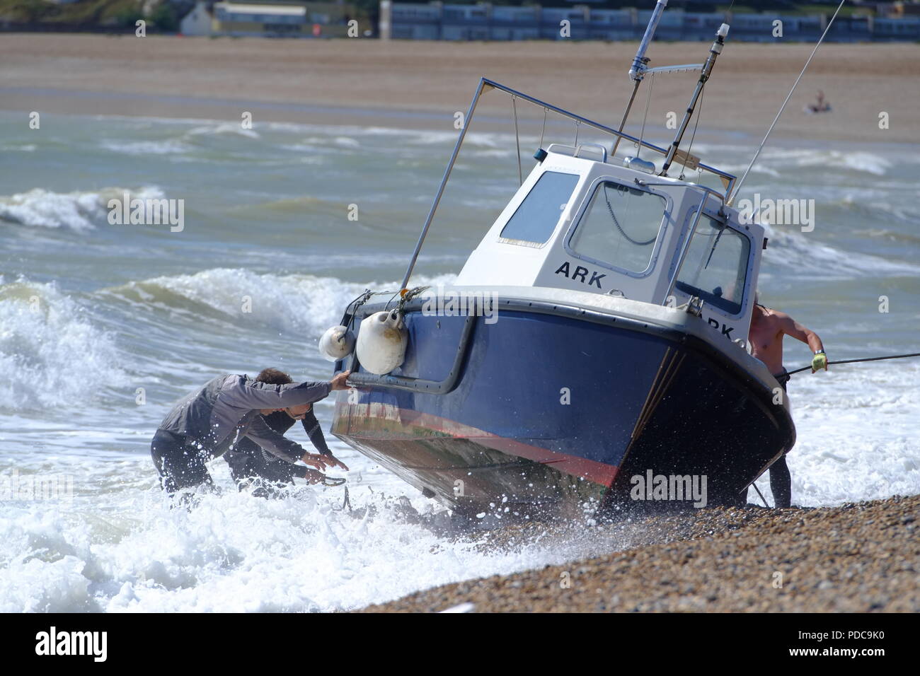 Seaford, East Sussex, UK. fishing boat washes up on Seaford beach after strong winds. Stock Photo