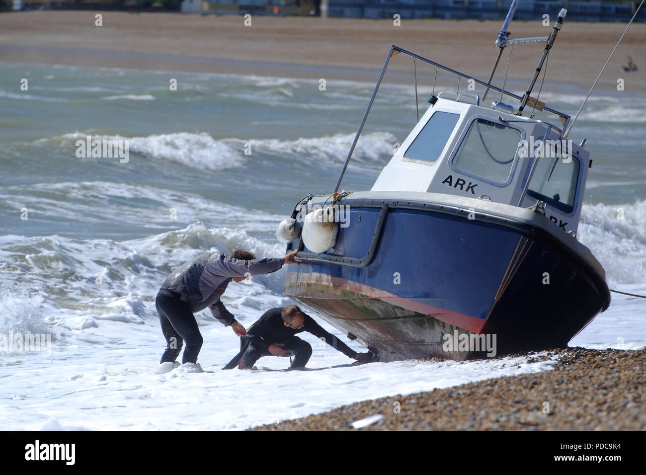 Seaford, East Sussex, UK. fishing boat washes up on Seaford beach after strong winds. Stock Photo
