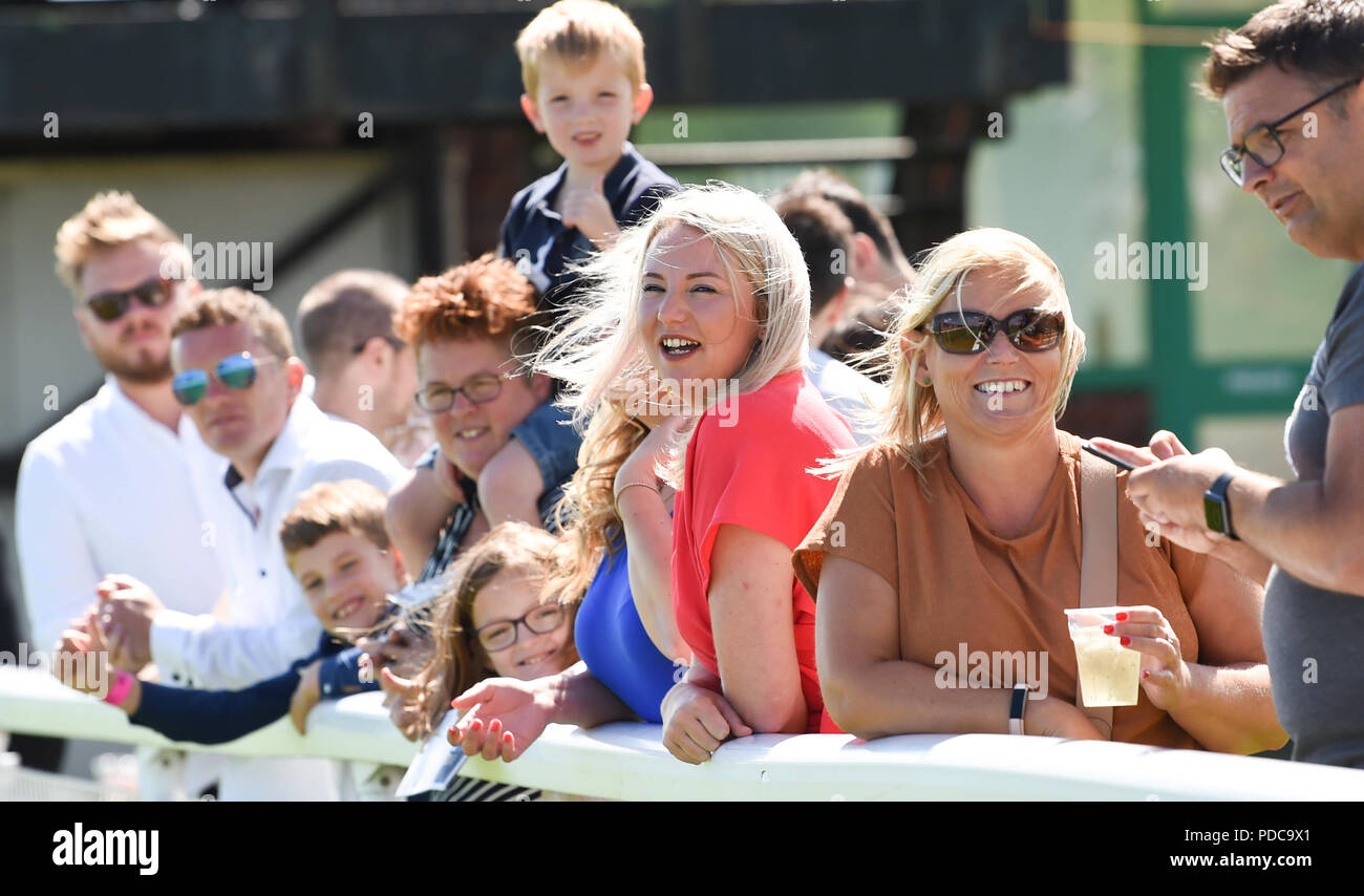 Brighton UK 8th August 2018 -  Th windy but bright weather played havoc with the hair at the Brighton Races Marathonbet Festival of Racing Marstons Opening Day  Credit: Simon Dack/Alamy Live News Stock Photo