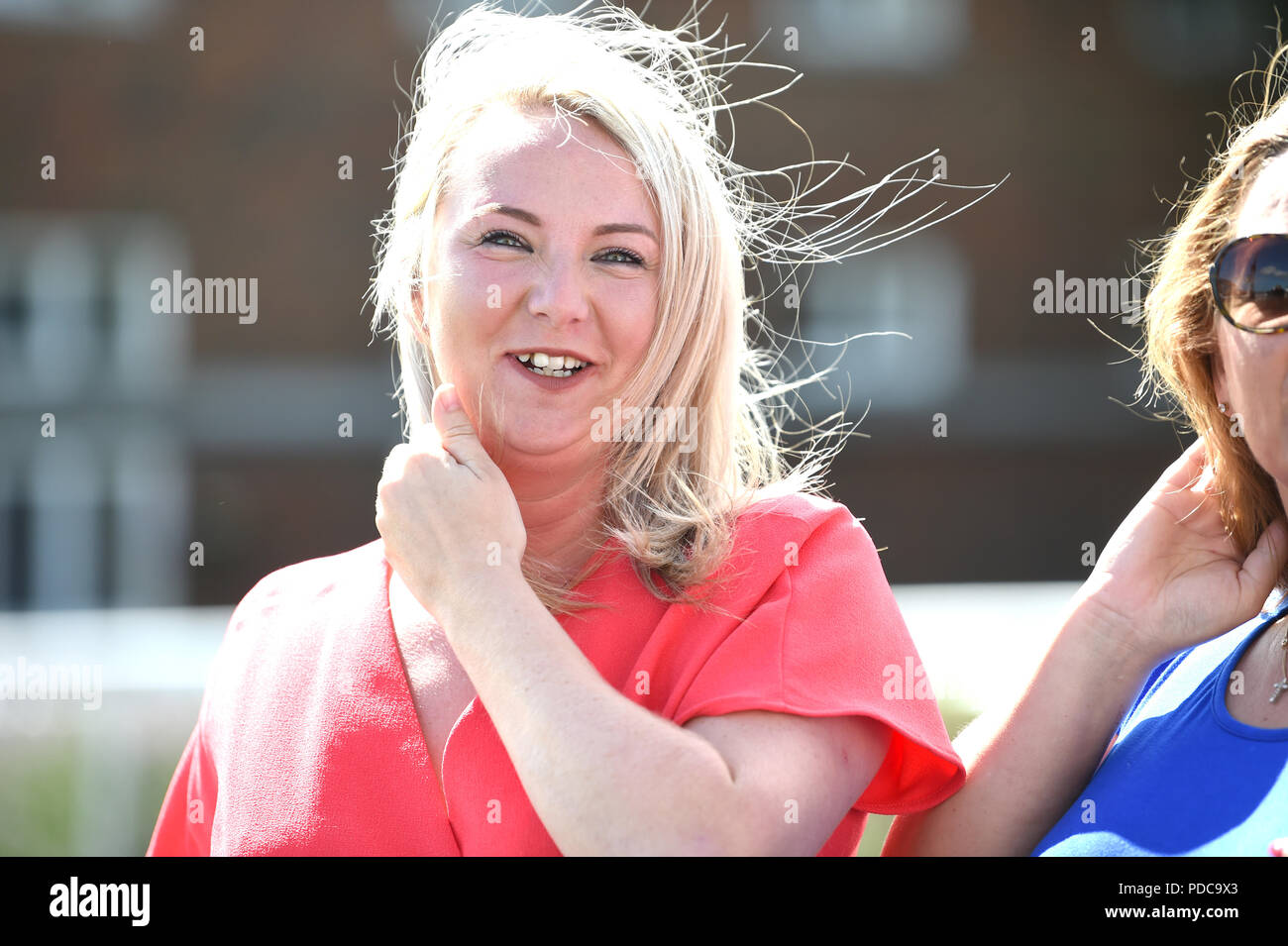 Brighton UK 8th August 2018 -  Th windy but bright weather played havoc with the hair at the Brighton Races Marathonbet Festival of Racing Marstons Opening Day  Credit: Simon Dack/Alamy Live News Stock Photo