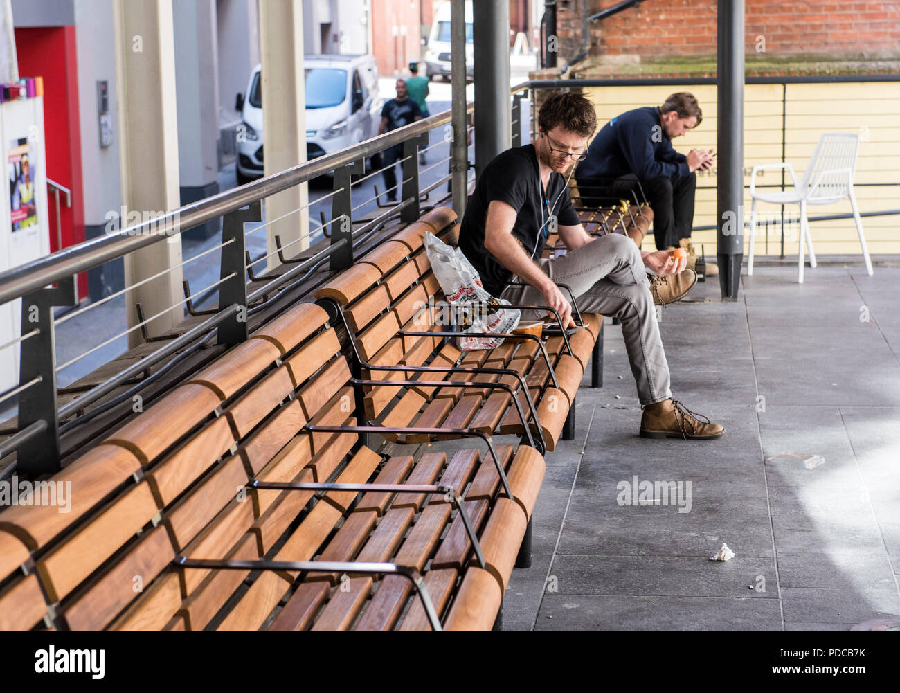 London, England, 08.08.2018.  People have lunch on the new controversial benches appeared in the area in front of the library of the School of Economics. Some students are outraged over the installation of the new metal hand rests as homeless people won't be able to lie down on the benches anymore. Ernesto Rogata/Alamy Live News. Stock Photo