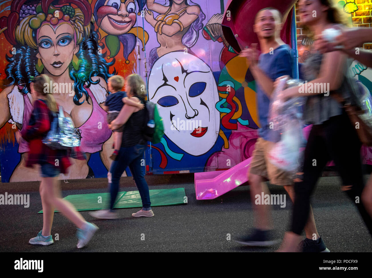 Roseburg, OREGON, USA. 8th Aug, 2018. Fair goers walk past carnival