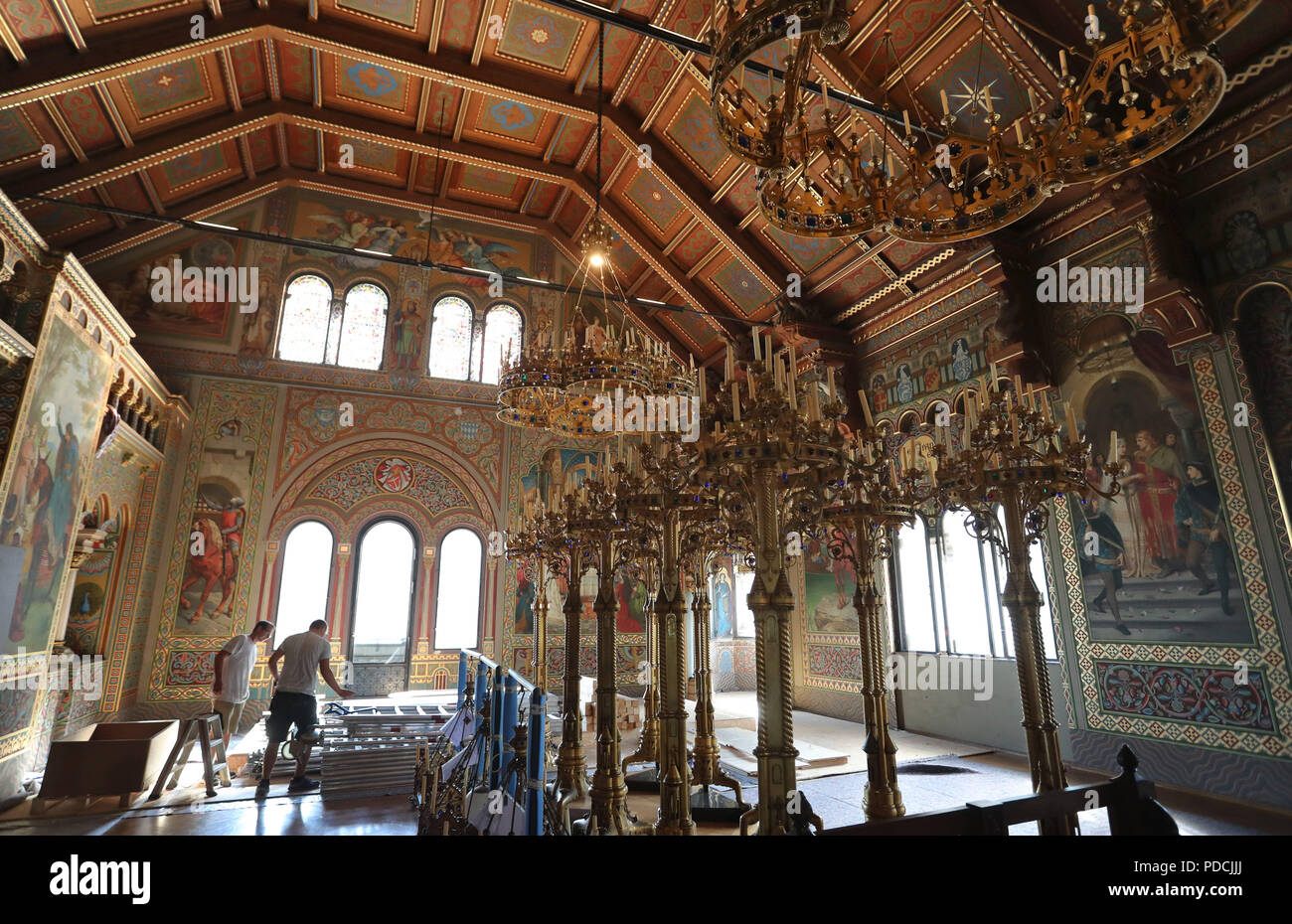 Schwangau, Germany. 09th Aug, 2018. Carpenters work in the Sängersaal of Neuschwanstein Castle next to assembled chandeliers. A press conference was held to inform about the restoration of the castle, which cost more than 20 million euros. Credit: Karl-Josef Hildenbrand/dpa/Alamy Live News Stock Photo