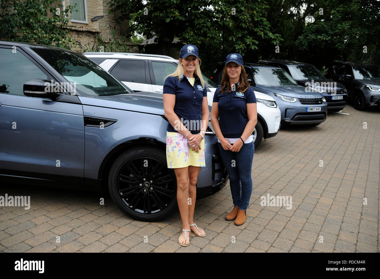 Stamford, Lincolnshire, UK. 9th August, 2018. 9th August 2018. Riders Sarah Cohen and Emily Prangnell pose in front of the Land Rover Discovery's during the 2018 Land Rover Burghley Horse Trials Media Preview Day, Stamford, United Kingdom. Jonathan Clarke/Alamy Live News Stock Photo