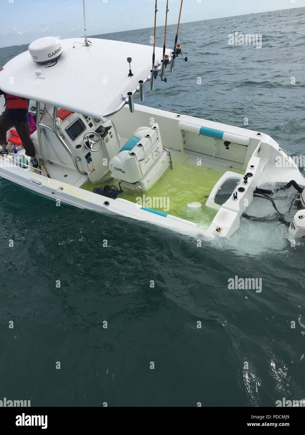 The Coast Guard prepares to transfer four mariners from their capsizing