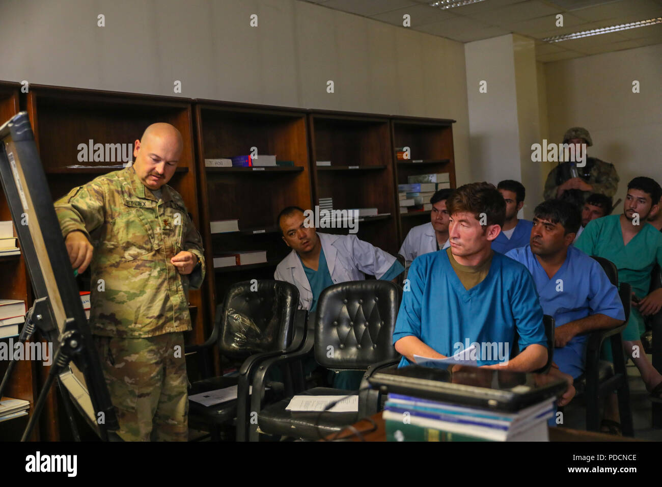 KANDAHAR PROVINCE, Afghanistan (Aug. 5, 2018) -- U.S. Navy Lt. Cdr. Travis J. Fitzpatrick, senior nurse for Kandahar Airfield NATO Role III Multinational Medical Unit, goes over human anatomy, August 5, 2018, to begin his class on how to clear an airway on a patient during a medical advisory visit at Kandahar Regional Military Hospital, Camp Hero in Kandahar, Afghanistan. Staff members from the Role III conduct routine visits to KRMH to train and advise Afghan medical staff. (U.S. Army photo by Staff Sgt. Neysa Canfield/TAAC-South Public Affairs) Stock Photo