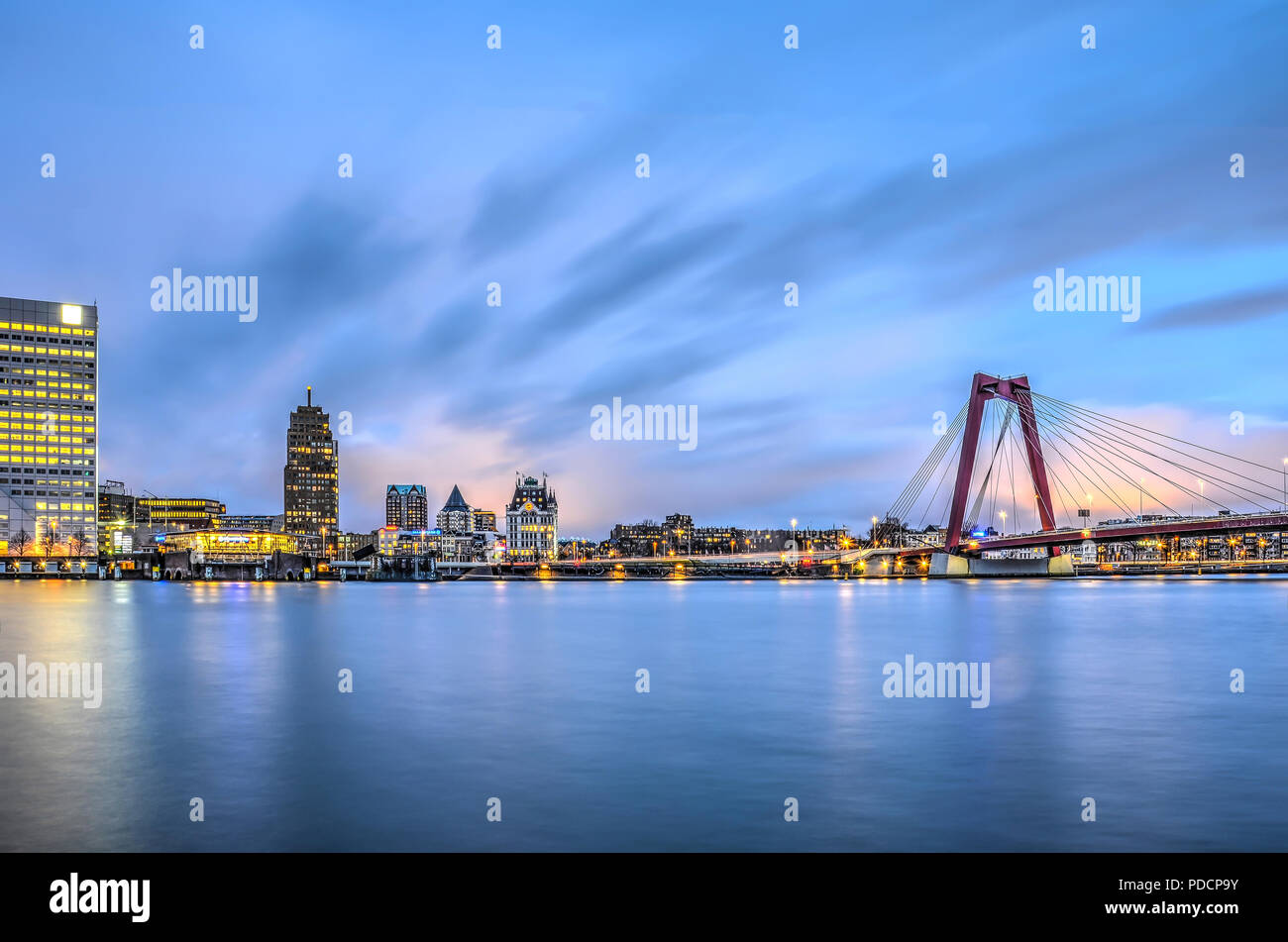 Rotterdam, The Netherlands, January 13, 2016: Spectacular sky showing the first sings of sunrise over the waterfront between Willemswerf and Willemsbr Stock Photo
