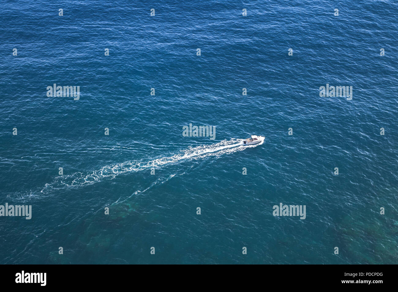 Fast motor boat goes on the ocean water, aerial photo Stock Photo