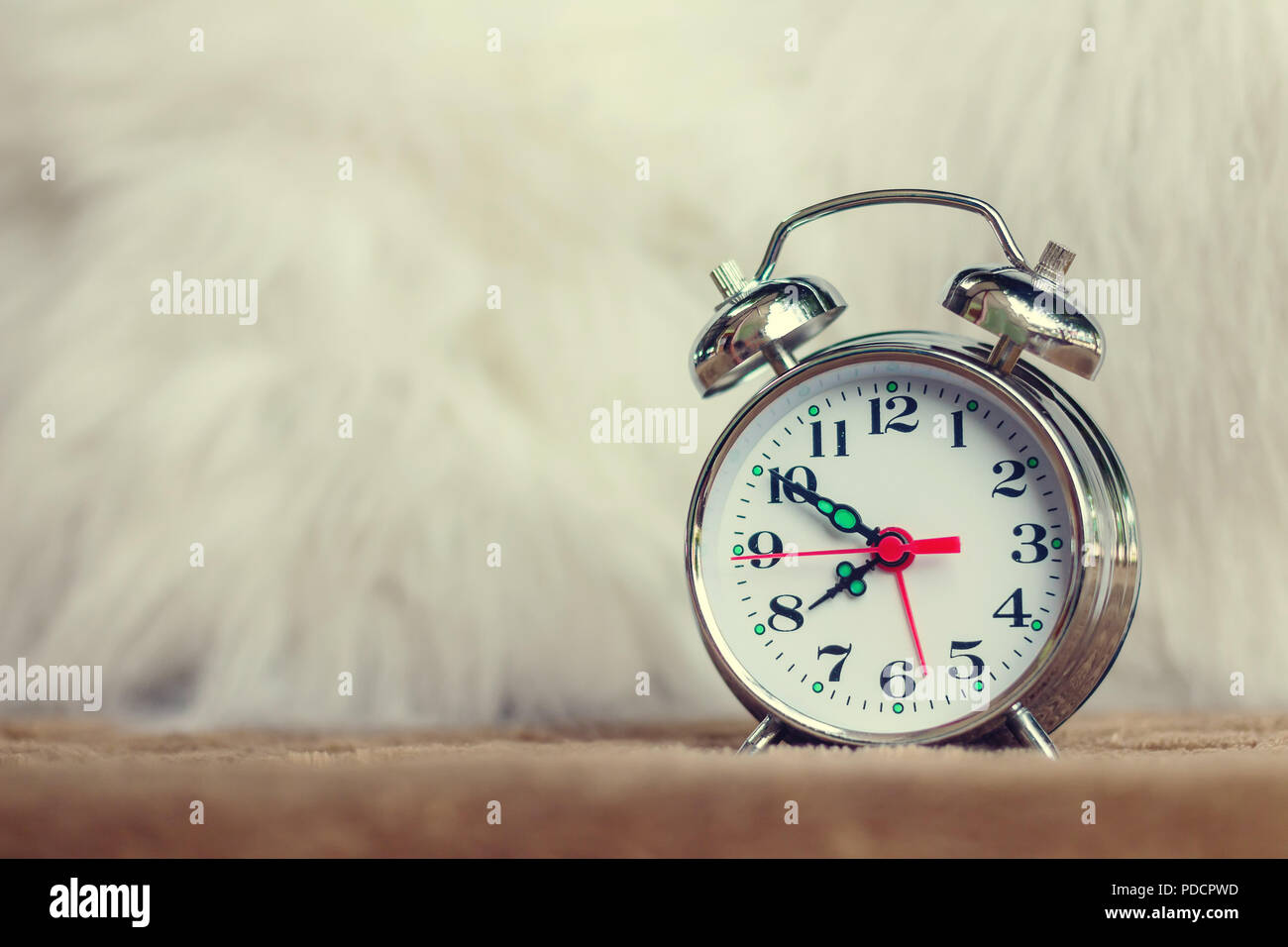 Vintage background with retro alarm clock on table Stock Photo - Alamy