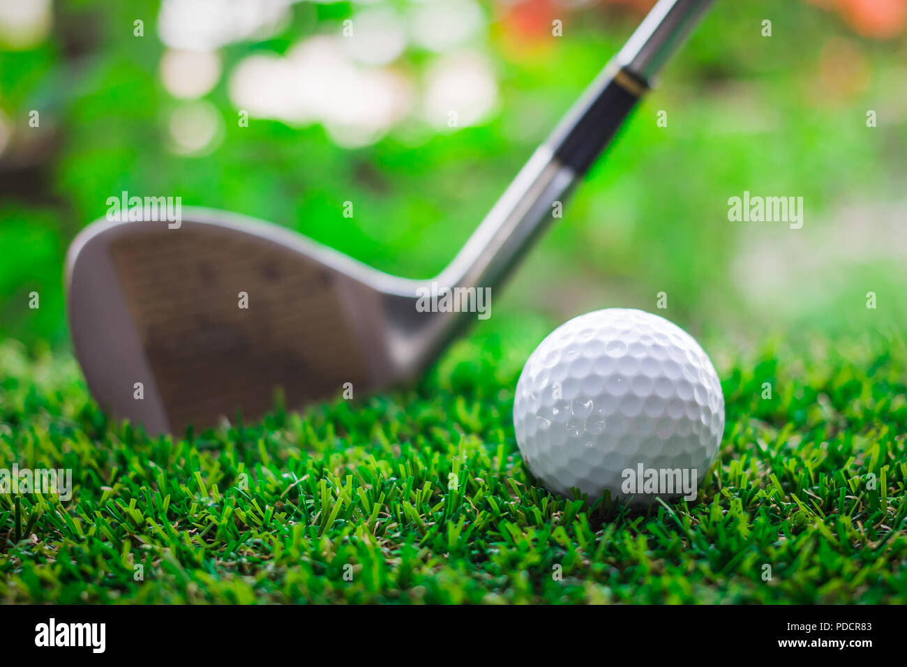 Golf club and ball on green grass Stock Photo - Alamy