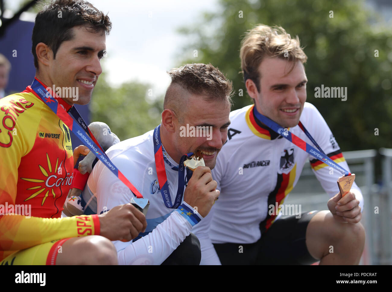 Gold medallist Belgium's Victor Campenaerts (centre), Silver medallist Spain's Jonathan Castroviejo (left) and bronze medallist Germany's Maximilian Schachmann in the Men's Time Trial on the podium during day seven of the 2018 European Championships at the Glasgow Cycling Road Race Course. Stock Photo