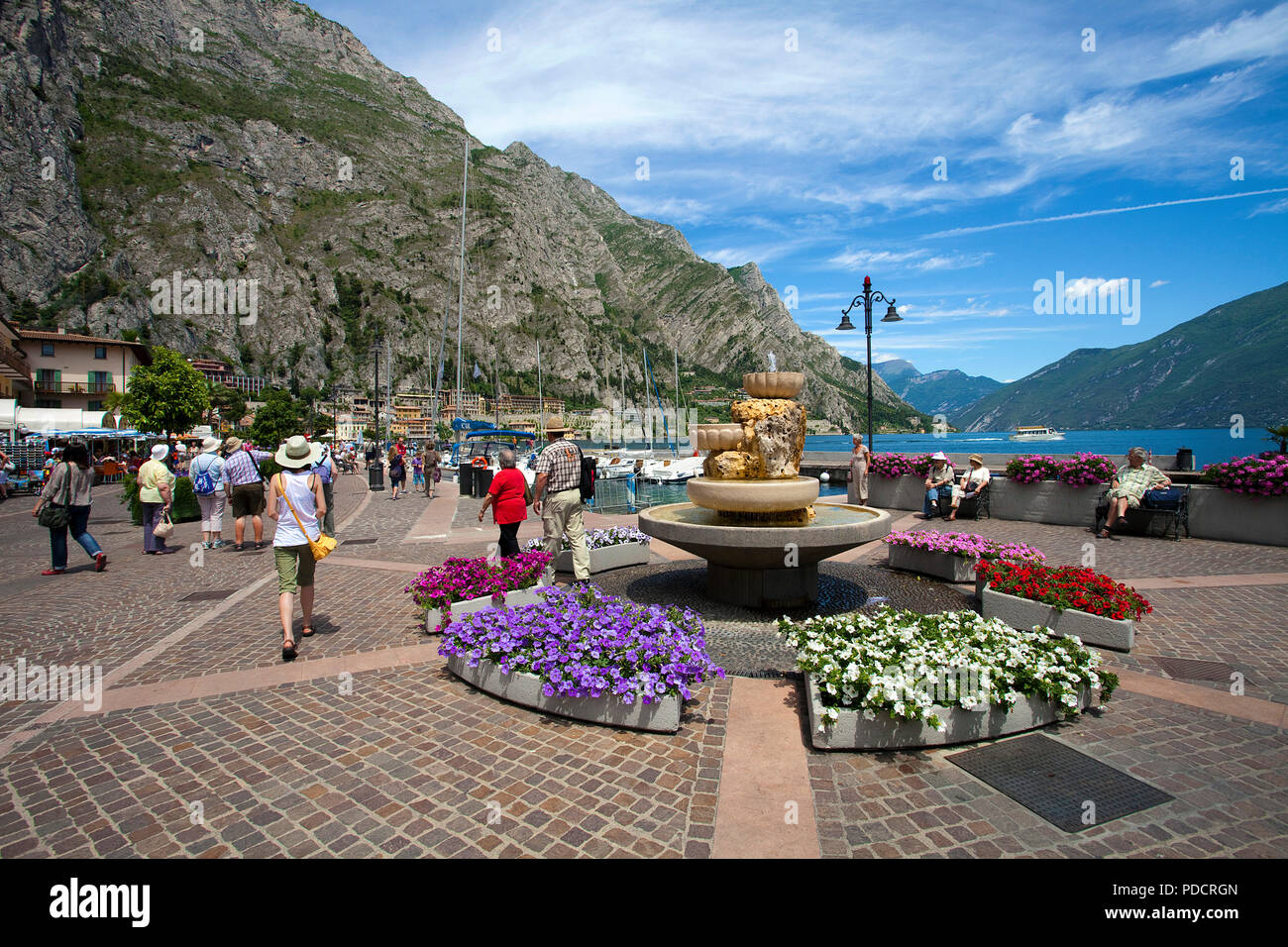 Flower decoration at lake promenade, fountain, Limone, Limone sul Garda, Lake Garda, Lombardy, Italy Stock Photo