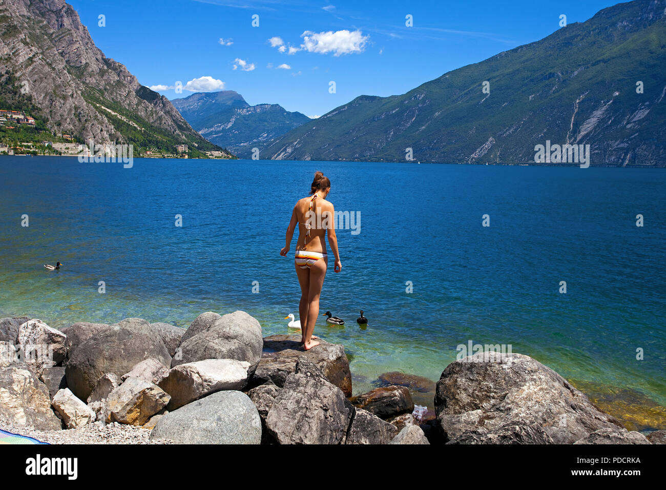 Young girl at the beach of Limone, Limone sul Garda, Garda lake, Lombardy, Italy Stock Photo