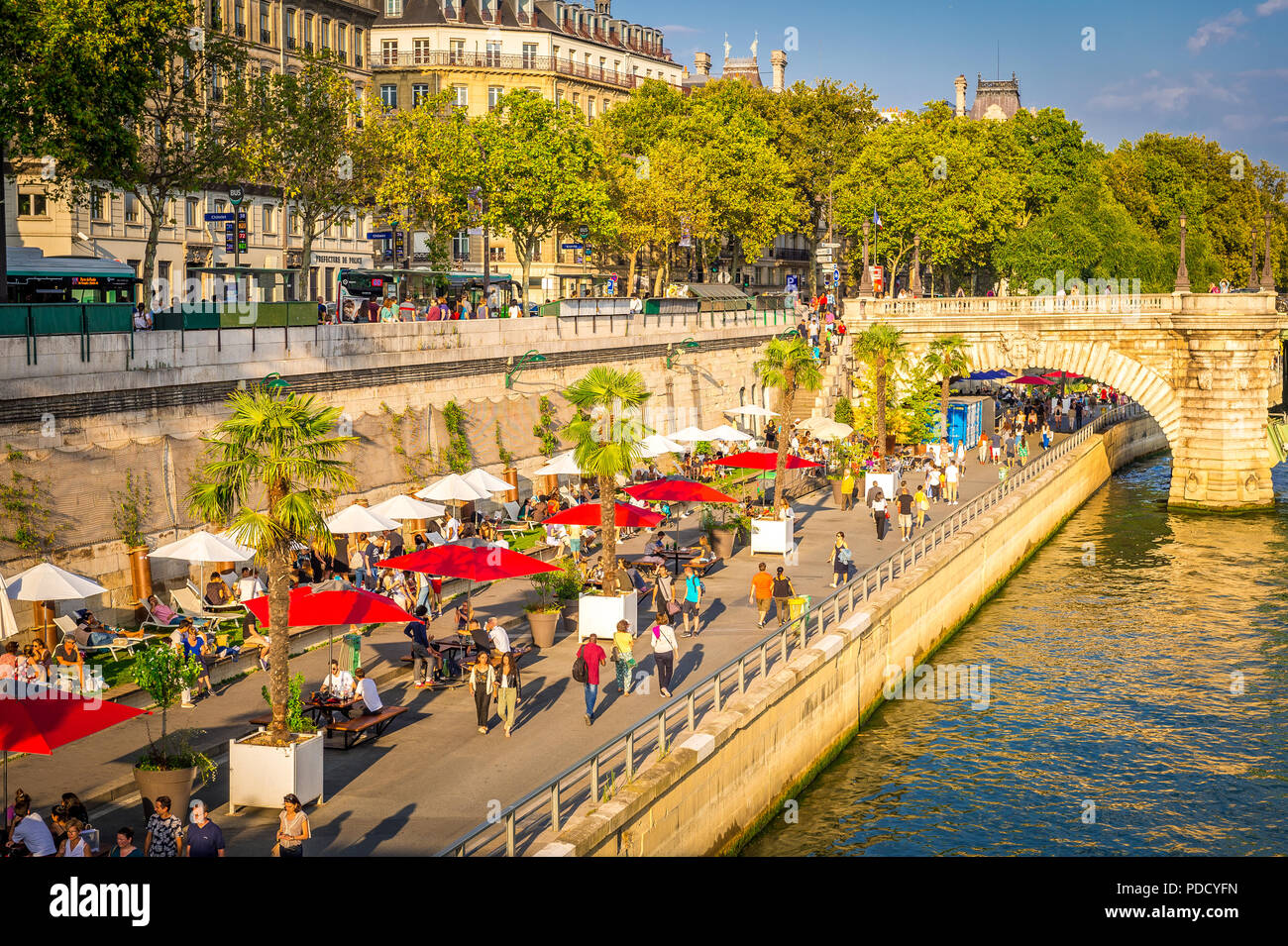 Parc Rives de Seine is a favourite place for tourists and locals to walk by the Seine River late in the afternoon in summer during the Paris plages. Stock Photo