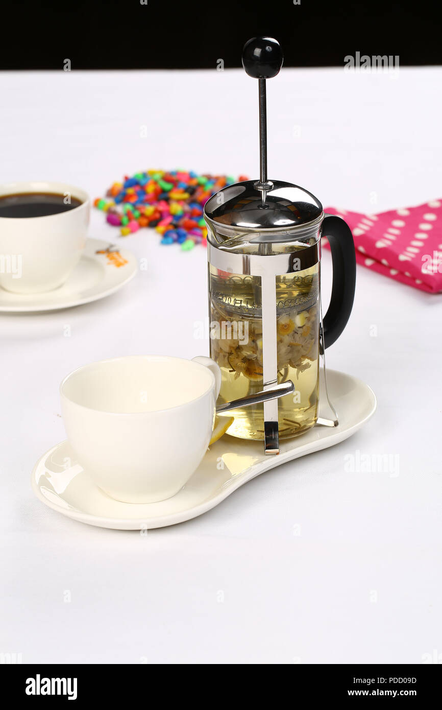 French press with cup of herbal tea on plate Stock Photo - Alamy
