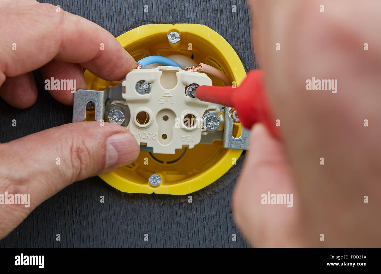 Replacement of electrical outlet in home electrical network, hands of