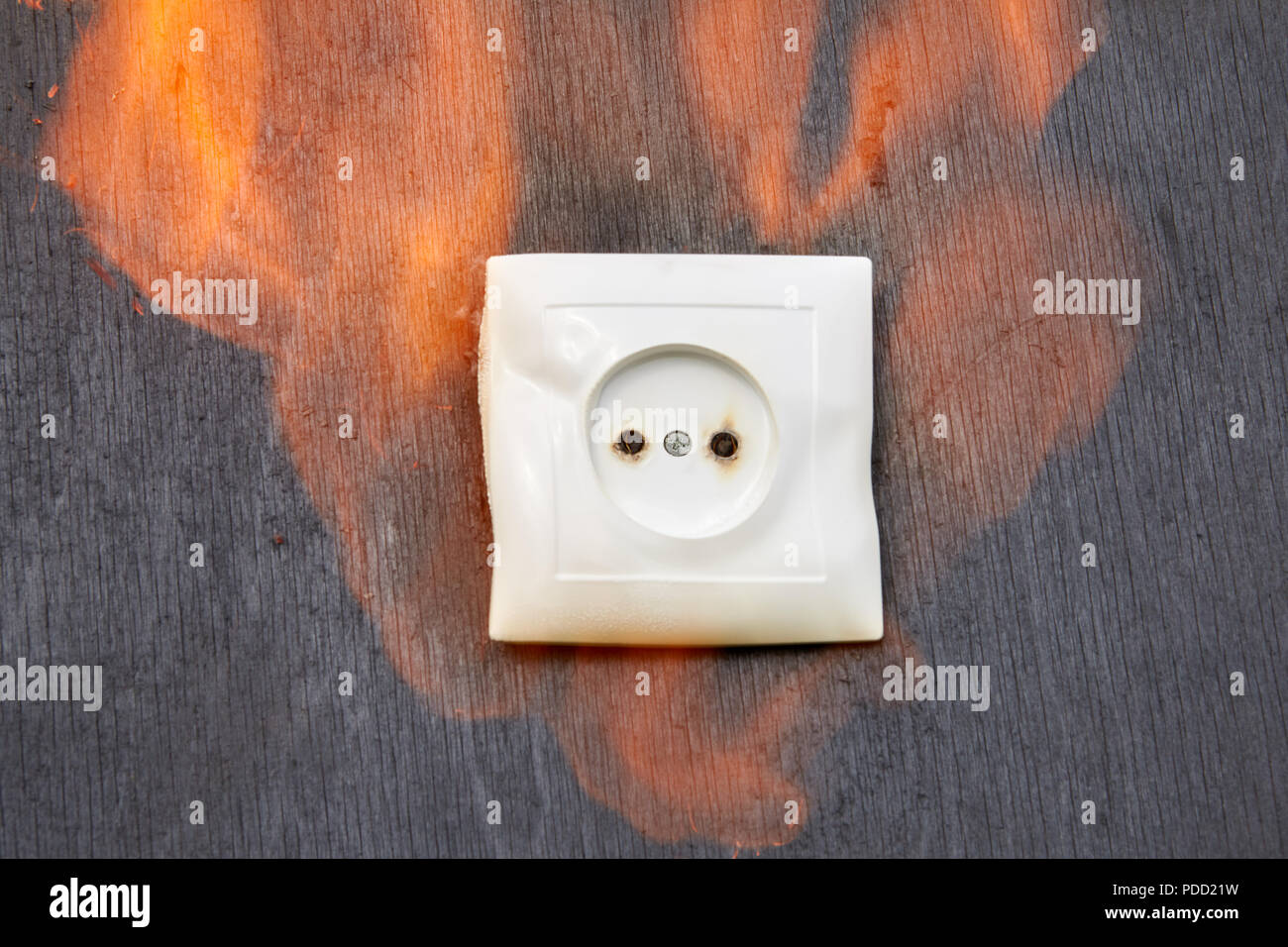 Household fire, Ignition of the plastic power socket. Stock Photo