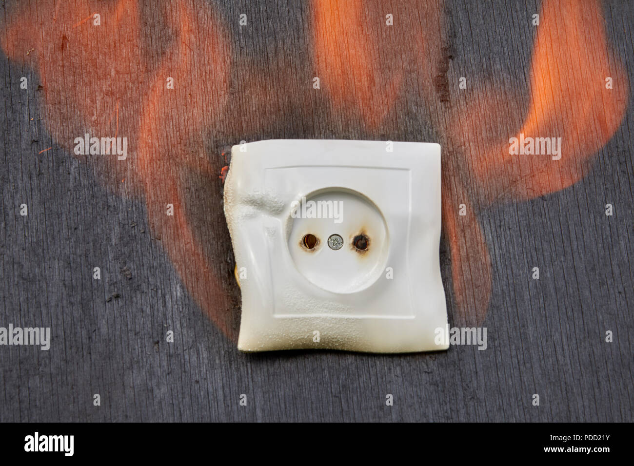 Defective wiring, fire plastic wall power socket. Stock Photo