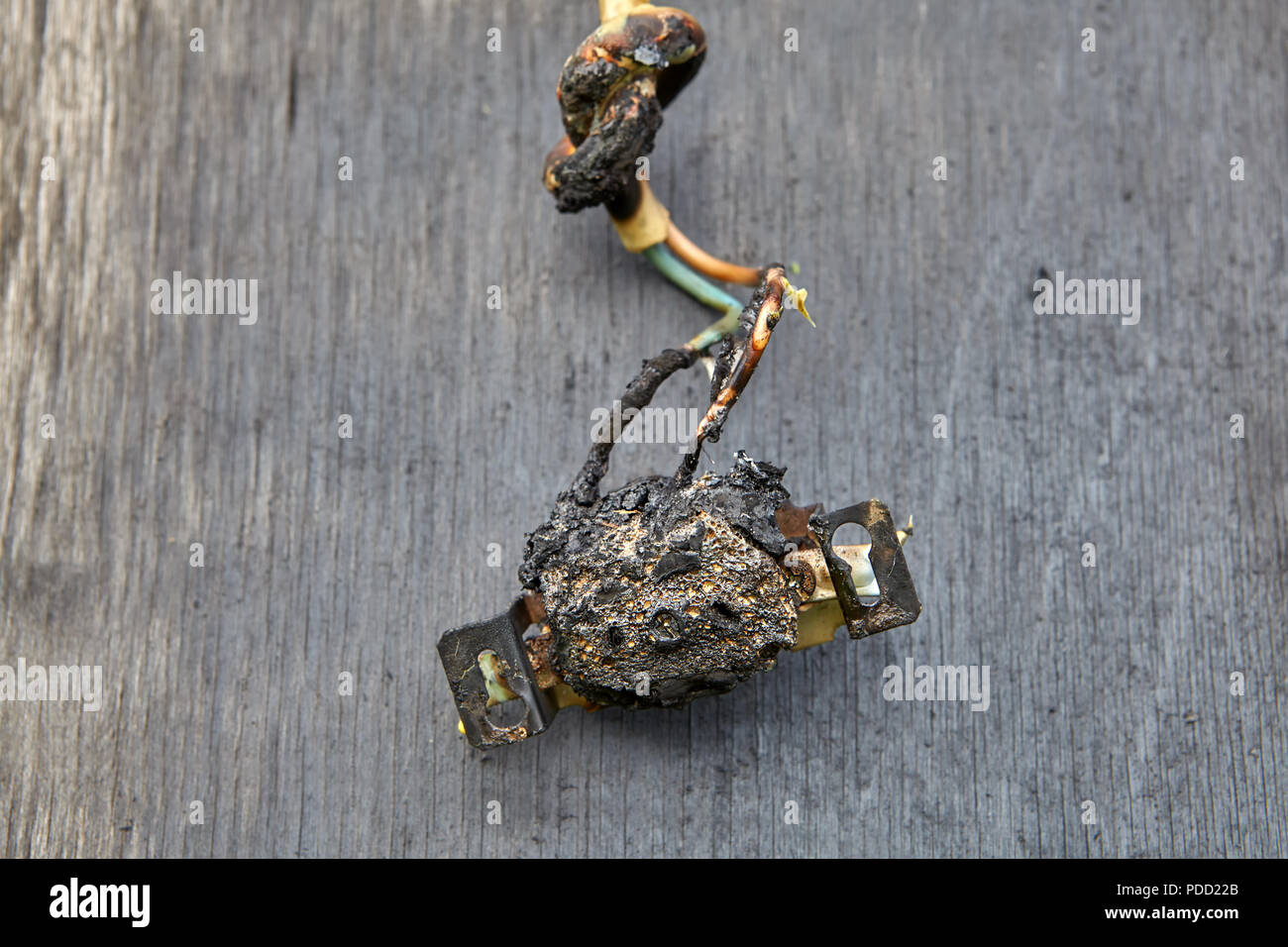 Melted-off and burned plastic socket of power supply. Stock Photo