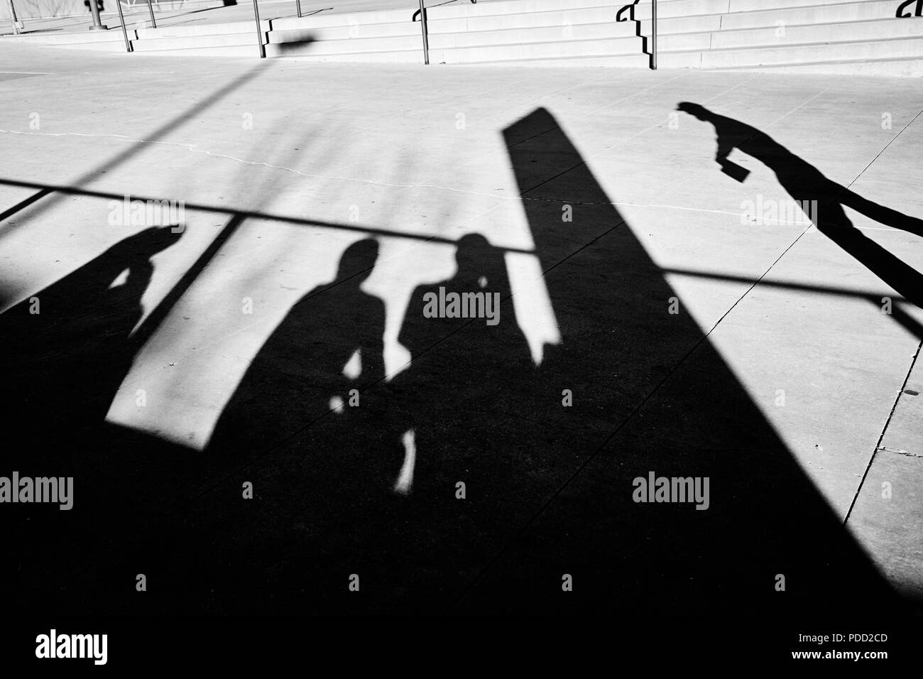 People silhouettes on a pavement, black and white street photo. Stock Photo