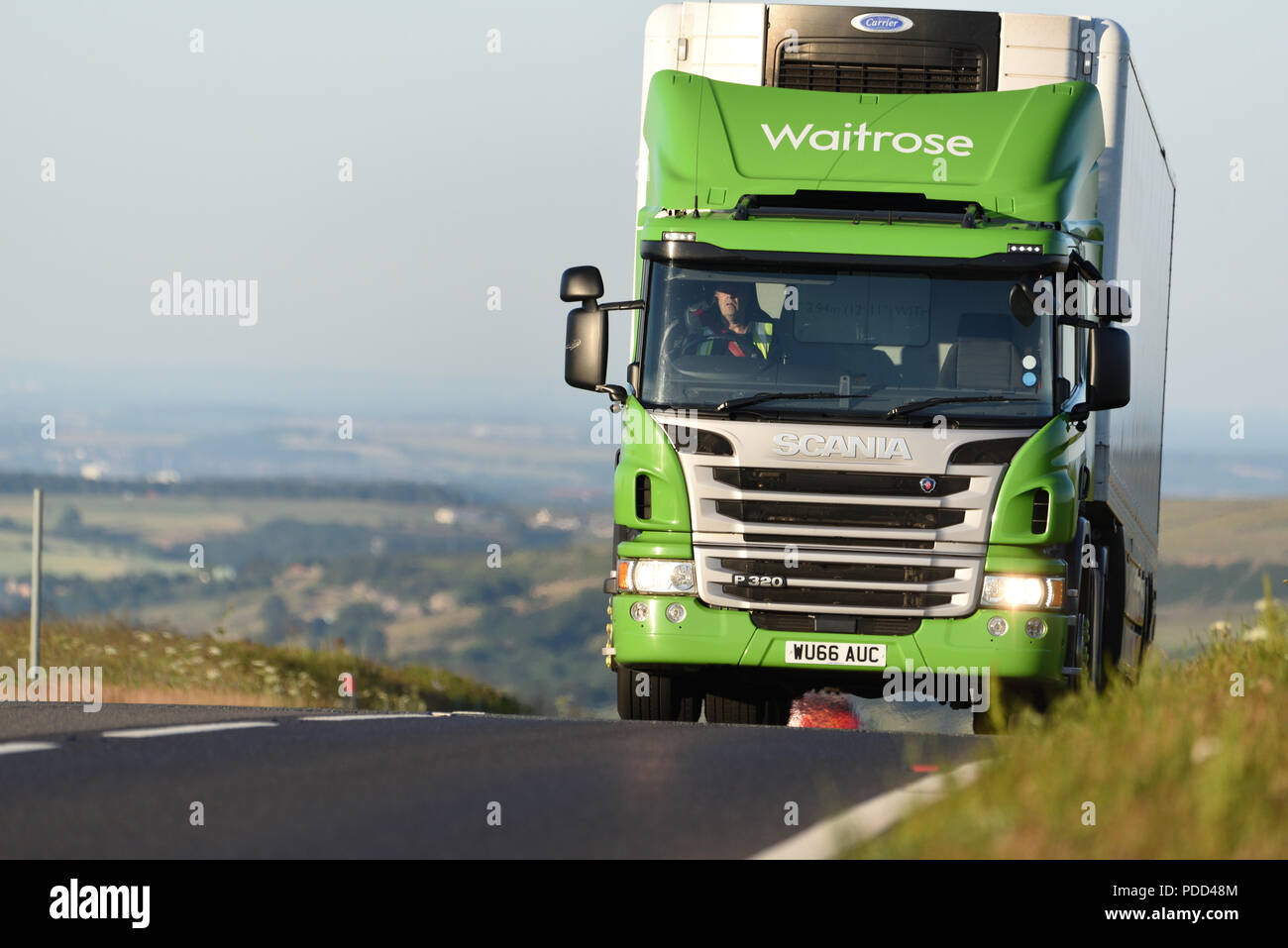 A Waitrose Scania powered by natural gas crests a hill on the Woodhead Pass, Yorkshire Stock Photo
