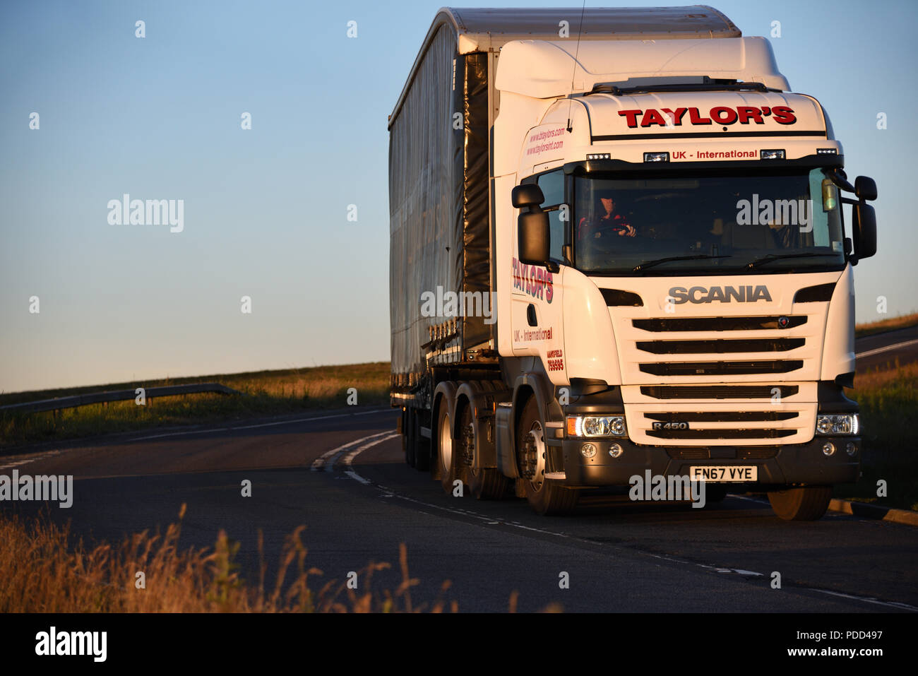Scania Truck Pulling A Curtainsider Trailer Takes Corner On The Scania Truck Pulling A Curtainsider Trailer Takes Corner On The Woodhead Pass Yorkshire At Dusk