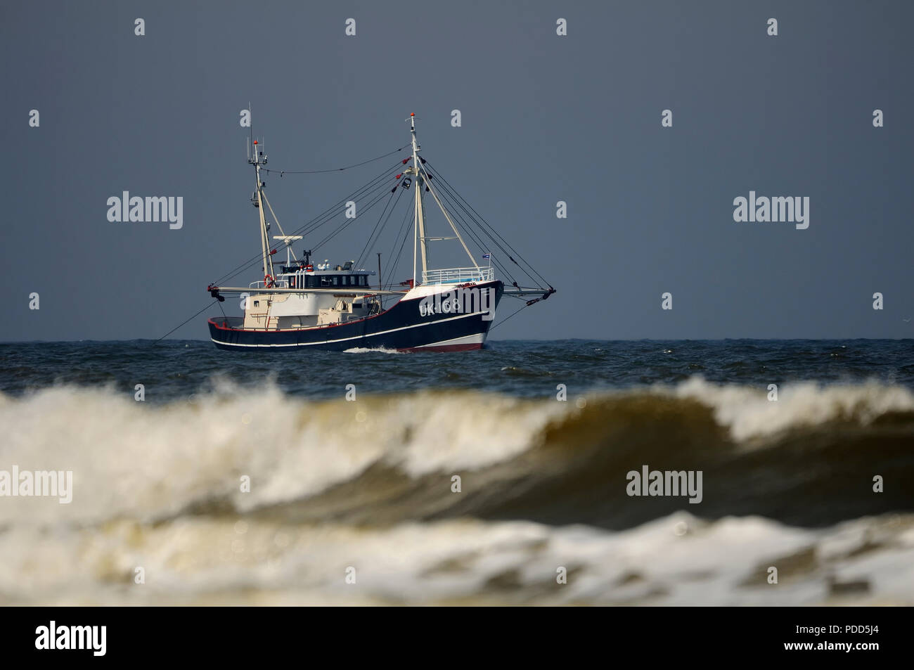 Fishing boat called the UK 168 fishing at sea Stock Photo
