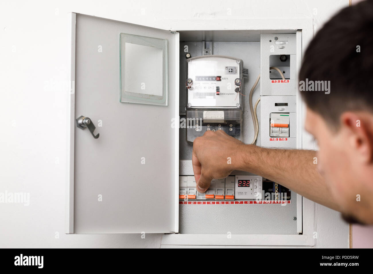 Electrical terminal box. man turn on or off Stock Photo - Alamy