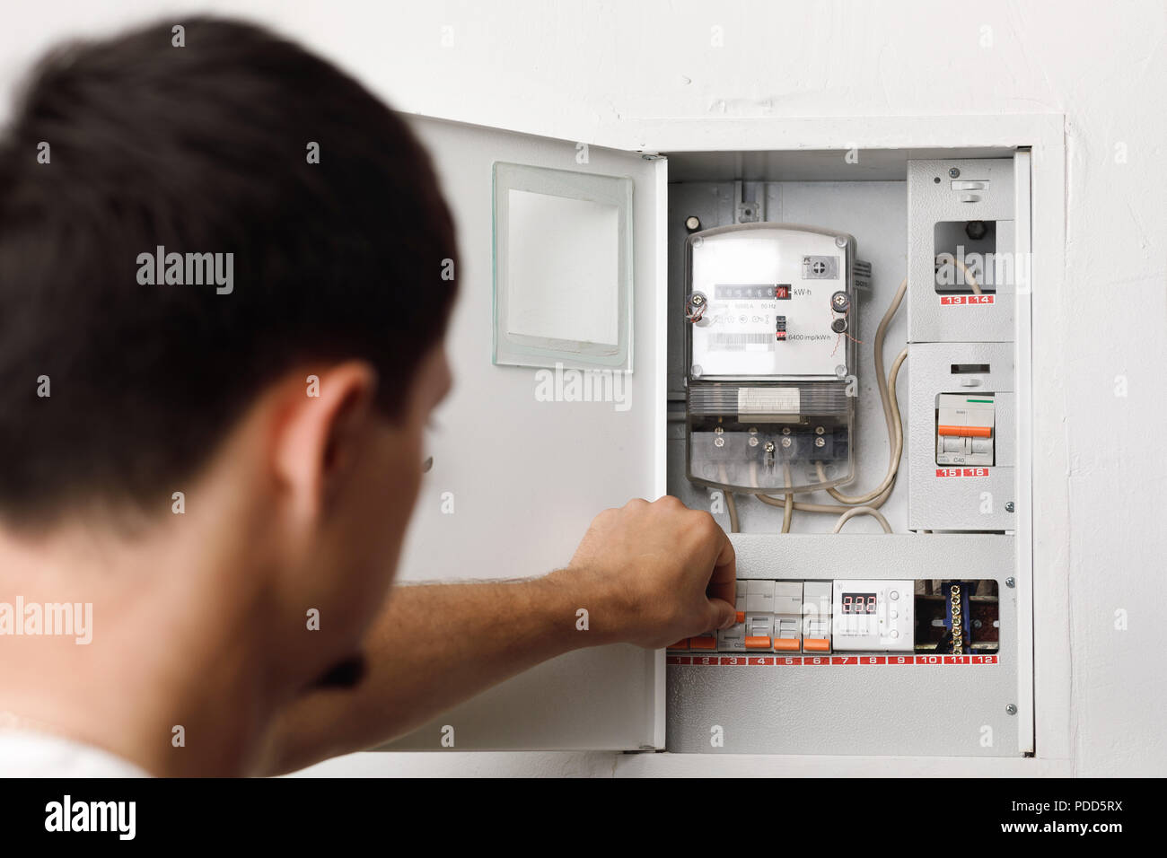 Electrical terminal box. man turn on or off Stock Photo