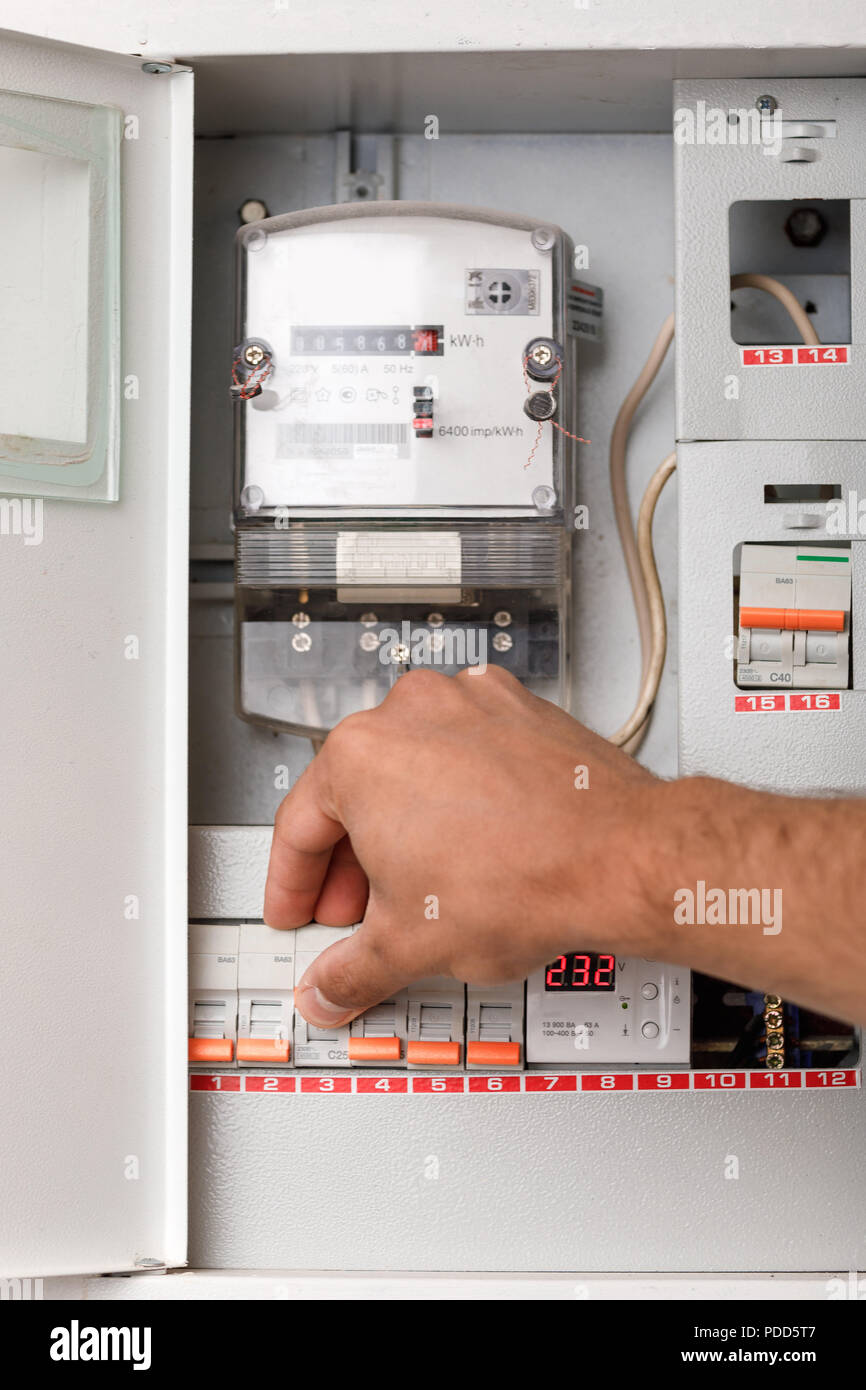 Electrical terminal box. man turn on or off Stock Photo