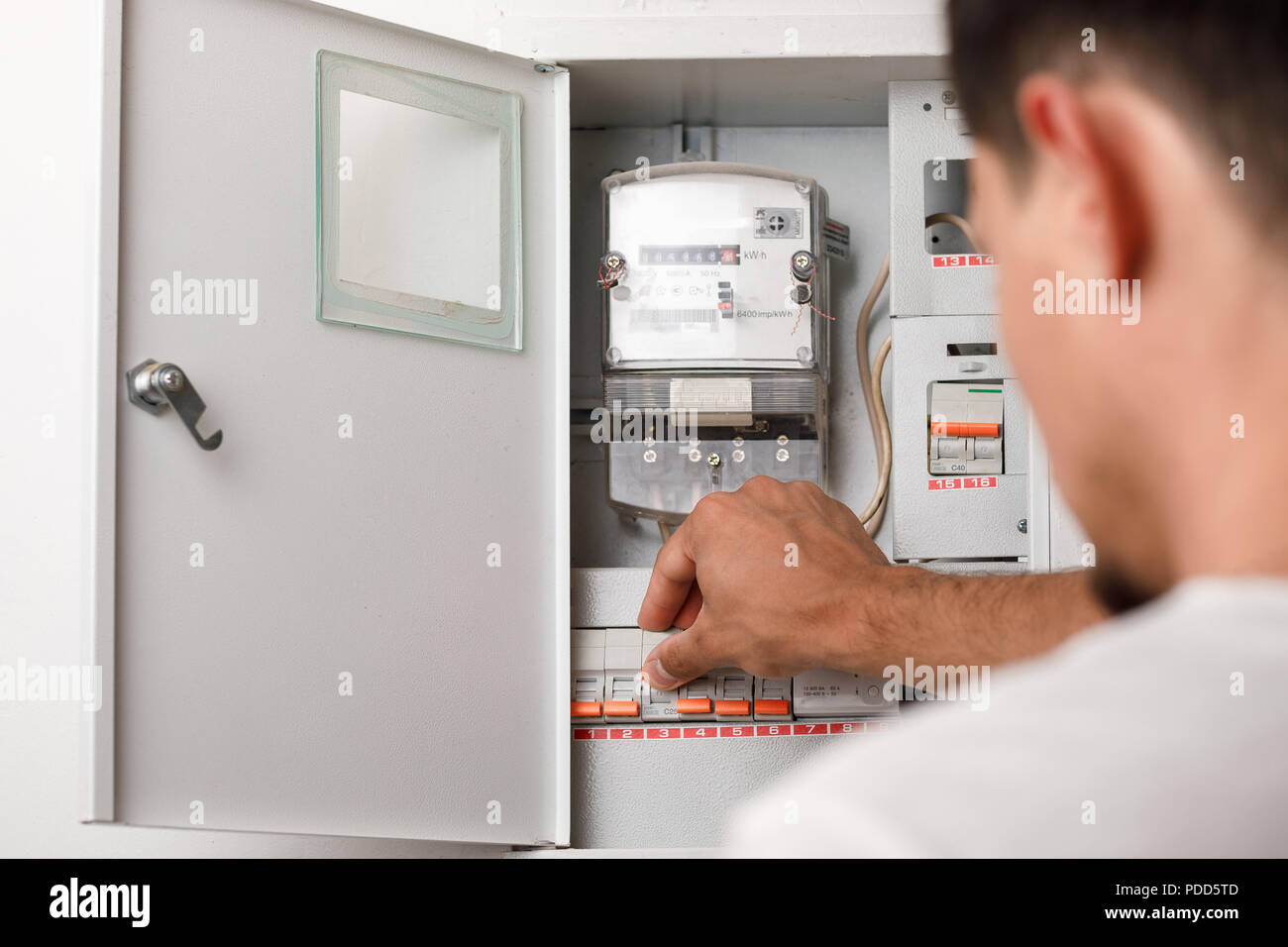 Electrical terminal box. man turn on or off Stock Photo