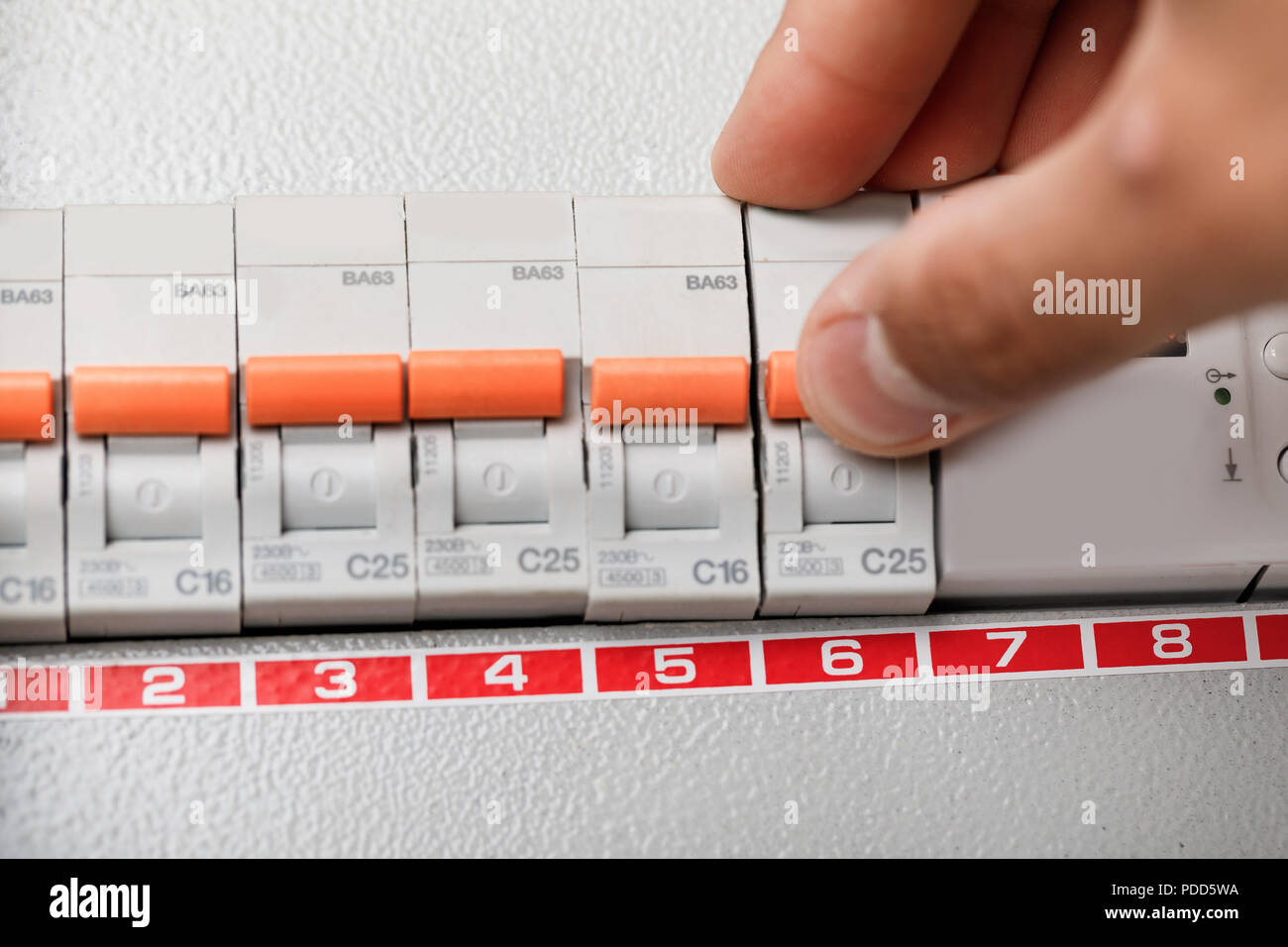 Electrical terminal box. man turn on or off Stock Photo