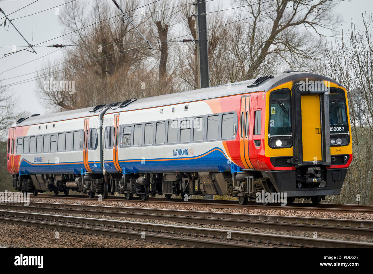 Class 158 train in East Midlands Trains livery travelling through the English countryside. Stock Photo