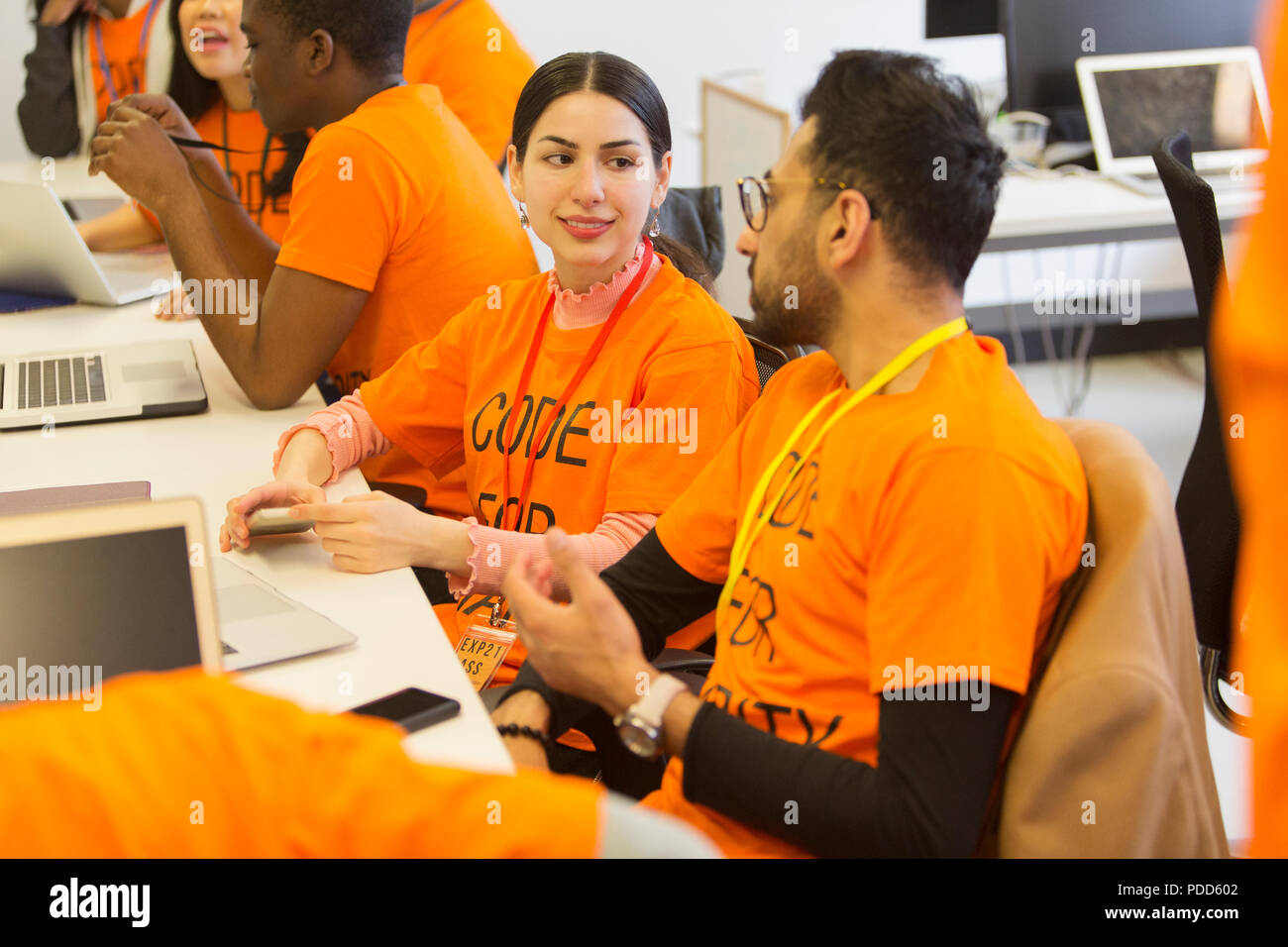 Hackers coding for charity at hackathon Stock Photo
