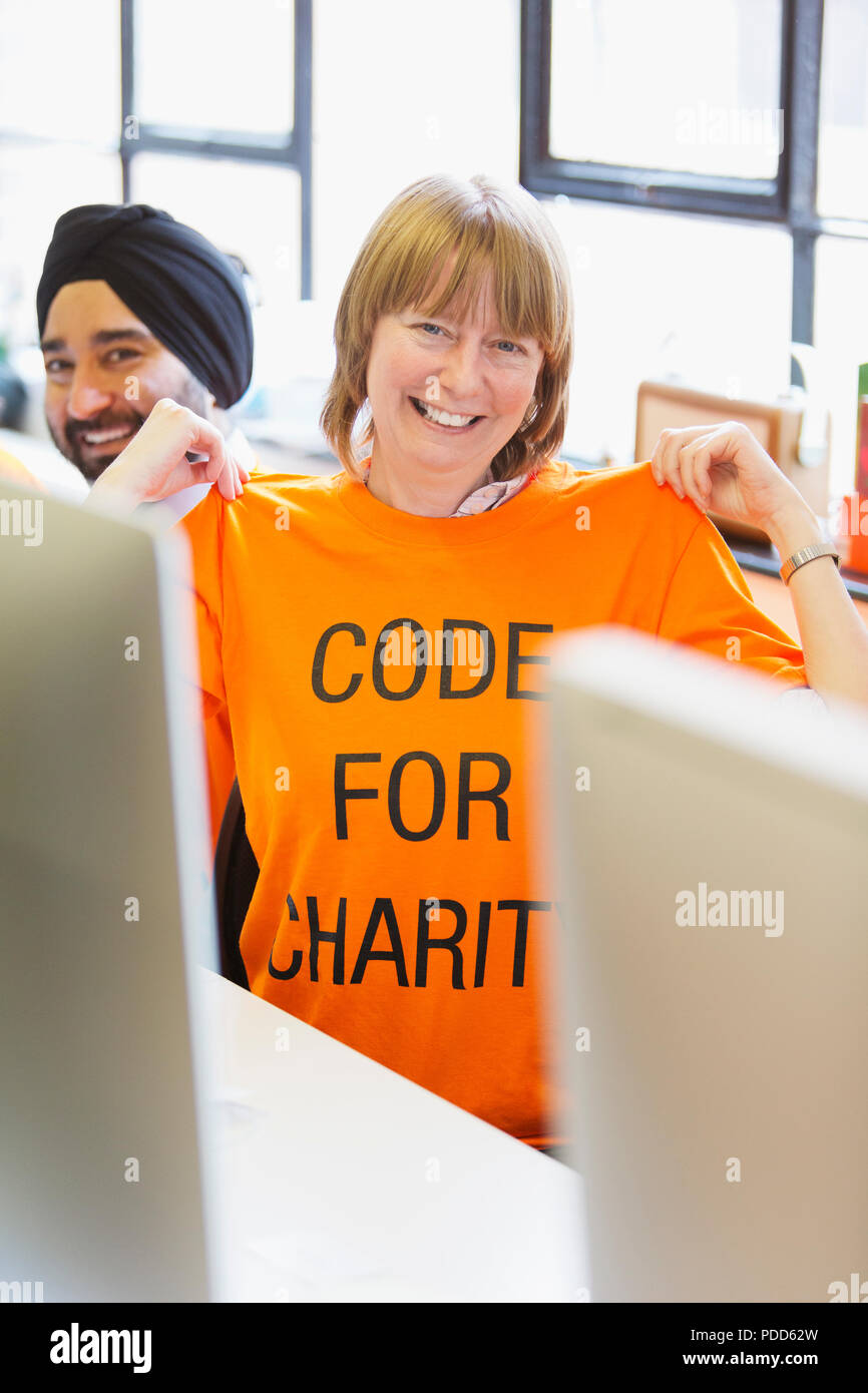 Portrait confident hacker wearing t-shirt, coding for charity at hackathon Stock Photo
