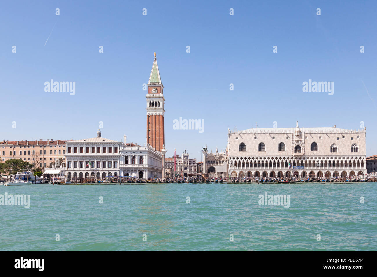 Doges Palace, St Marks Campanile and Marciana Library from the lagoon, Venice, Veneto, Italy with the Clock Tower and crowds of tourists in summer Stock Photo