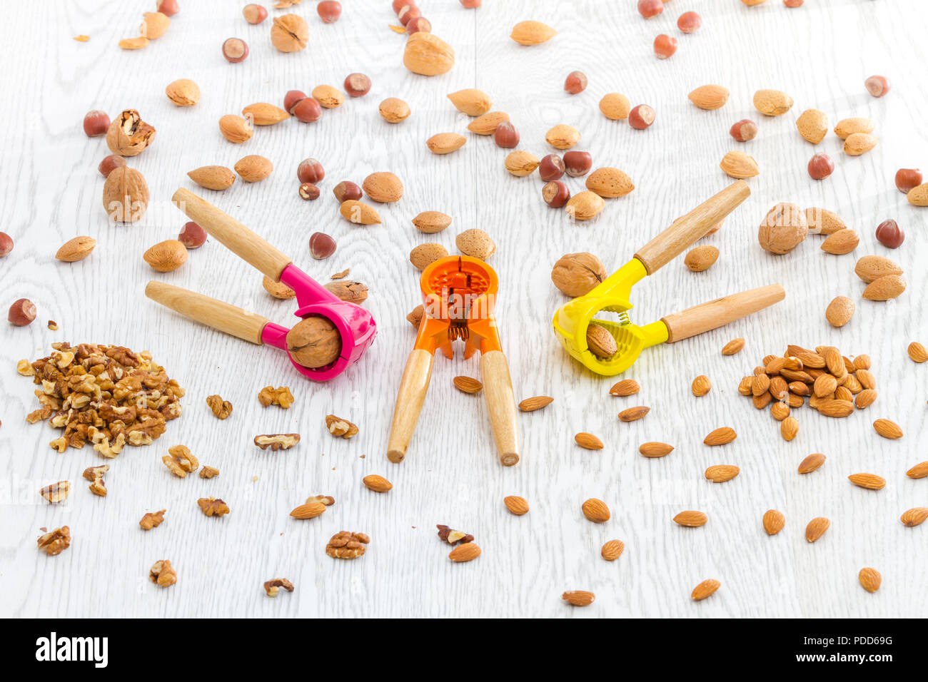 Stylish modern colorful nut crackers with various nuts in kitchen table
