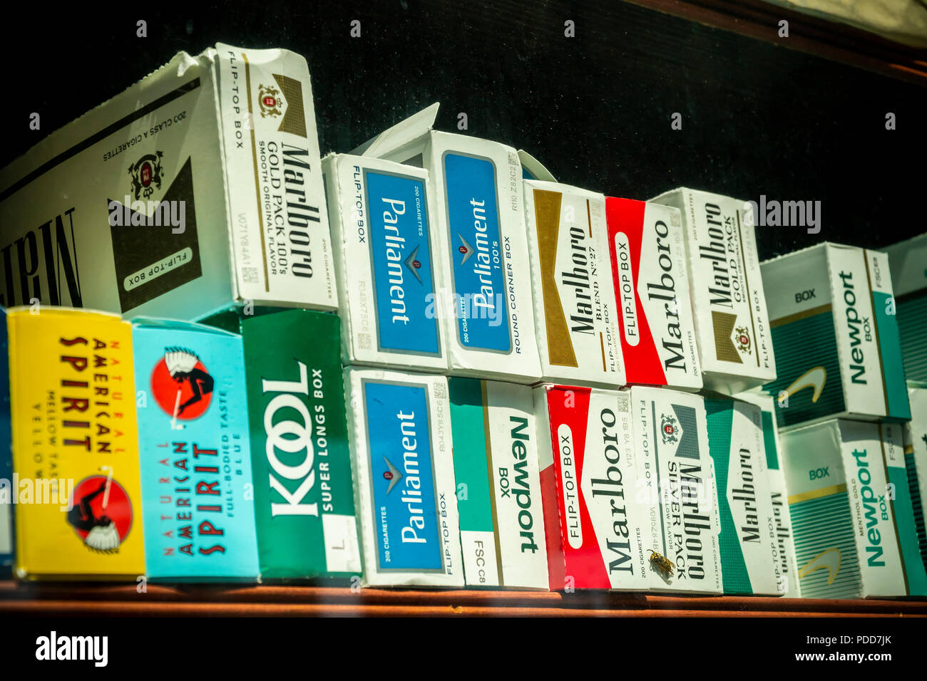 Cartons of cigarettes in the window of a grocery store in  Brooklyn inNew York on Sunday, August 5, 2018. (© Richard B. Levine) Stock Photo